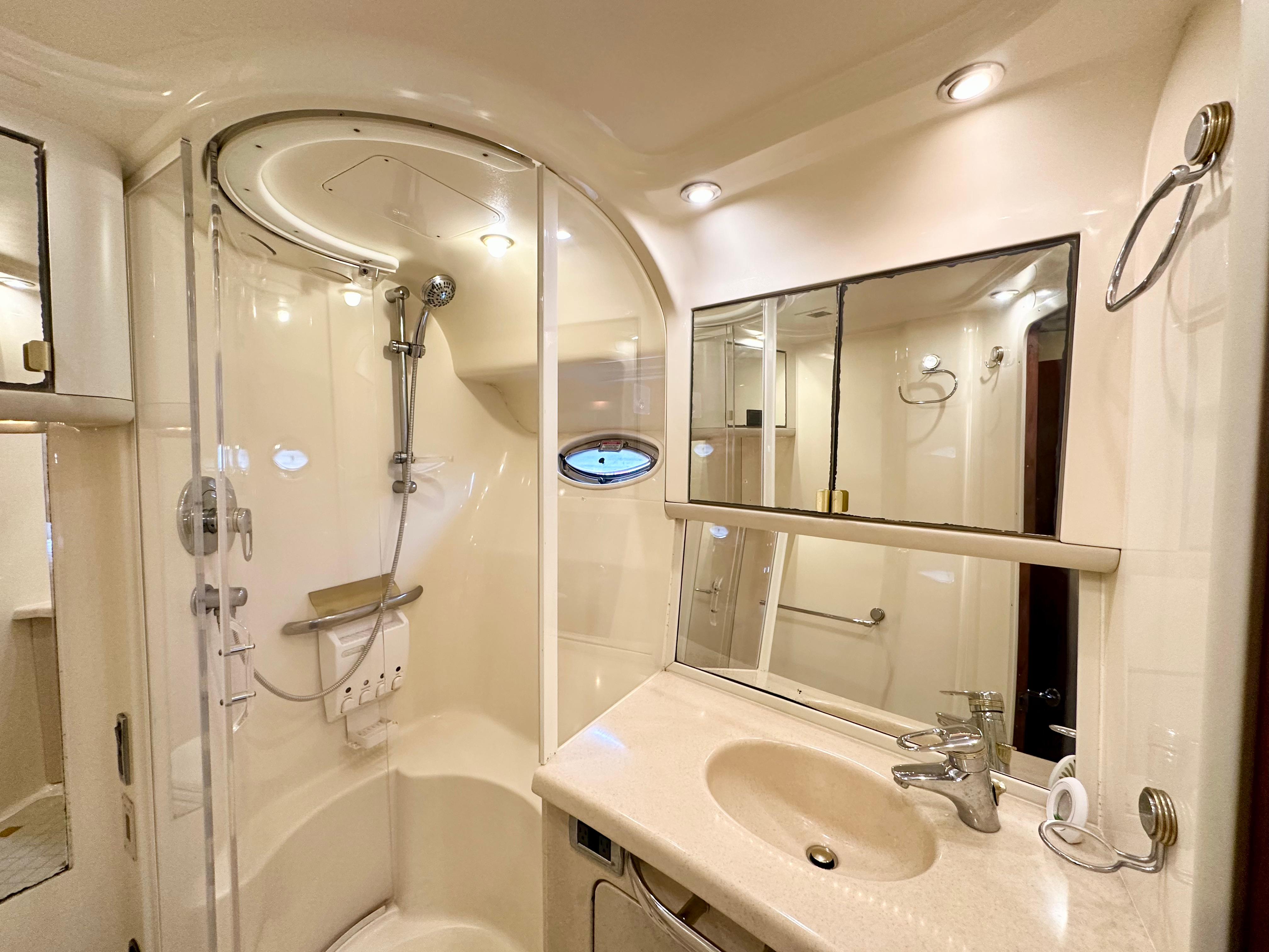 Luxurious bathroom in 2002 Sea Ray 560 Sedan Bridge yacht with shower and vanity.