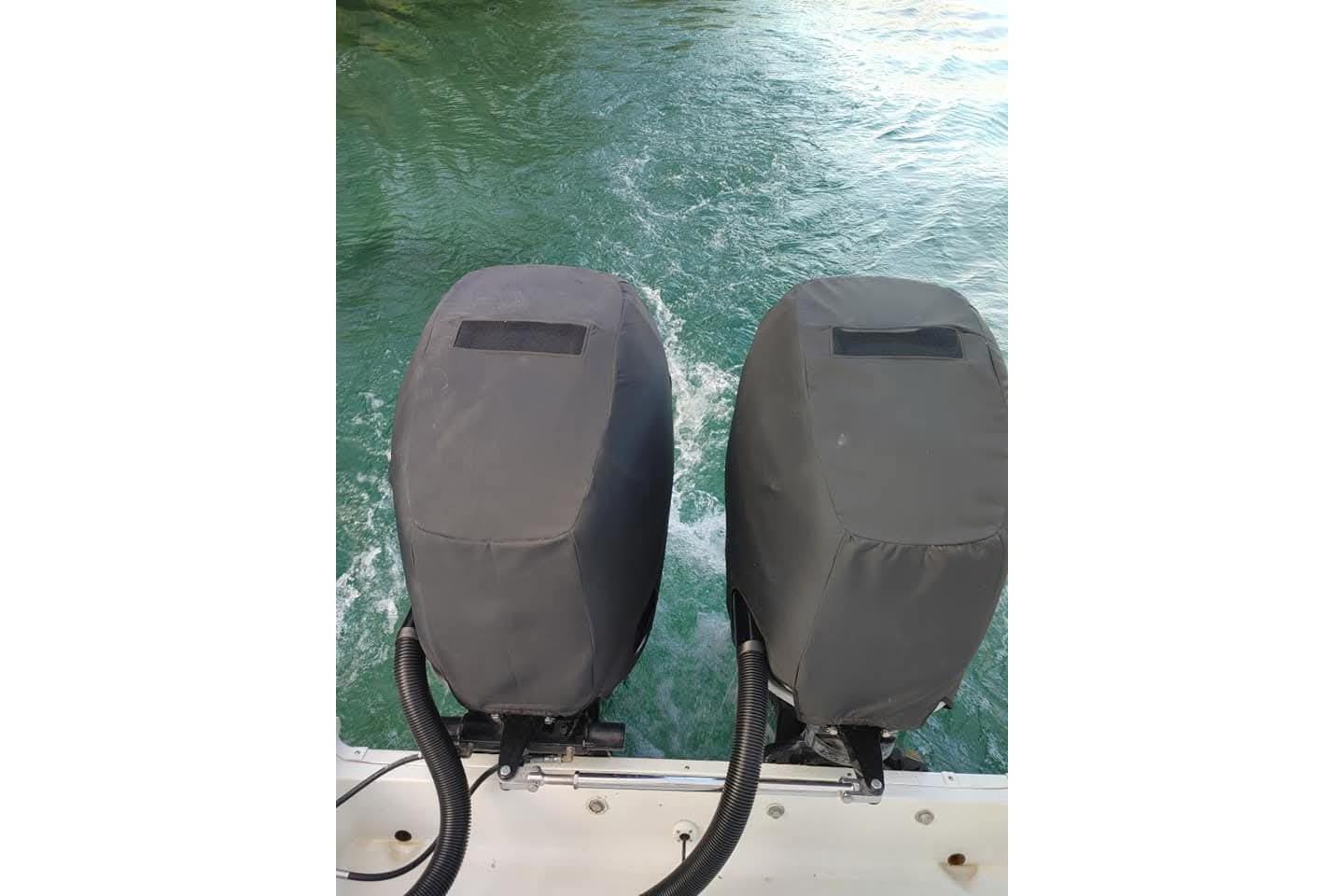 Twin outboard motors on a 2007 Seaswirl Striper 2901 Walkaround O/B, covered and ready for action.