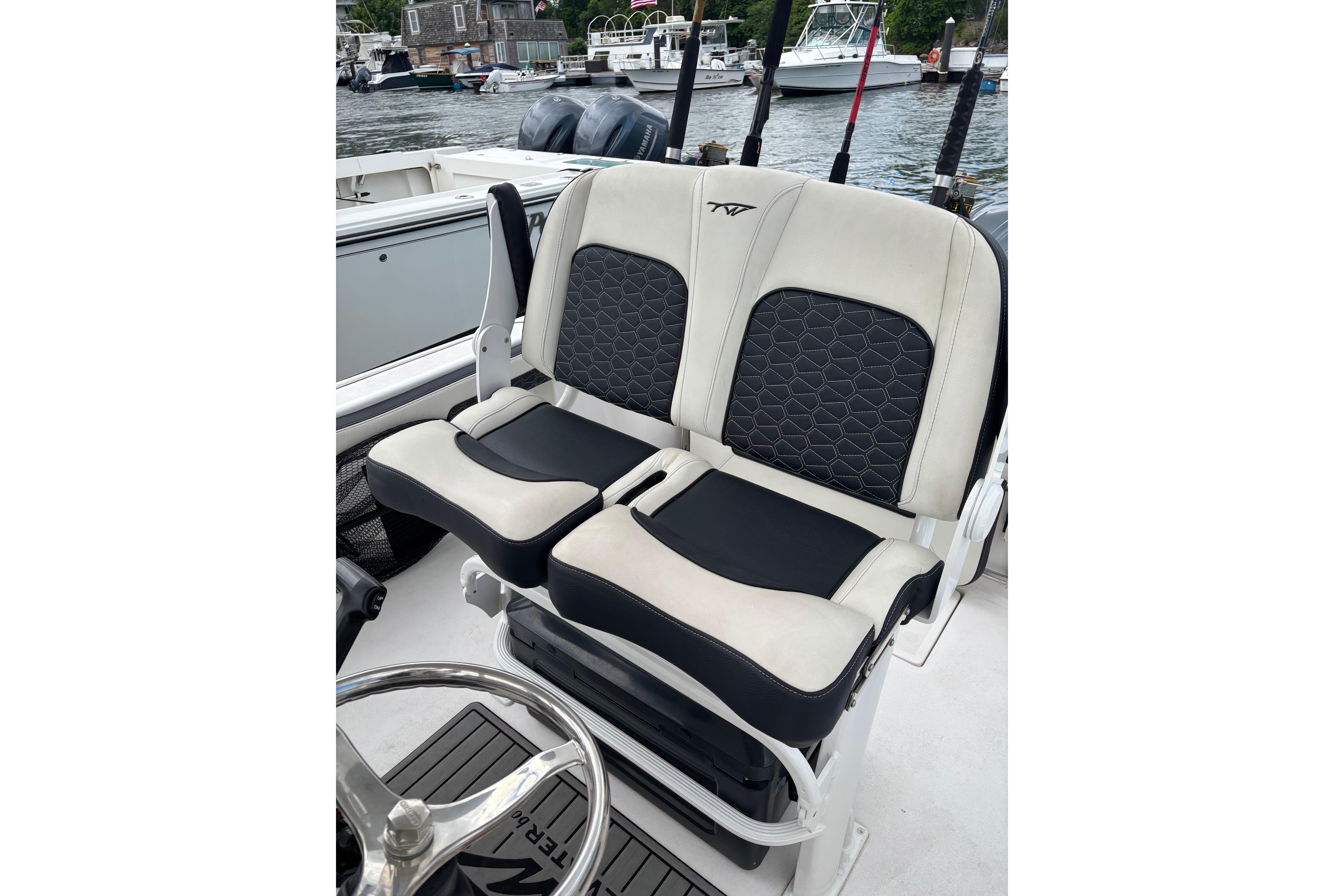 2024 Tidewater 220 CC Adventure boat seats with stylish black and white design.
