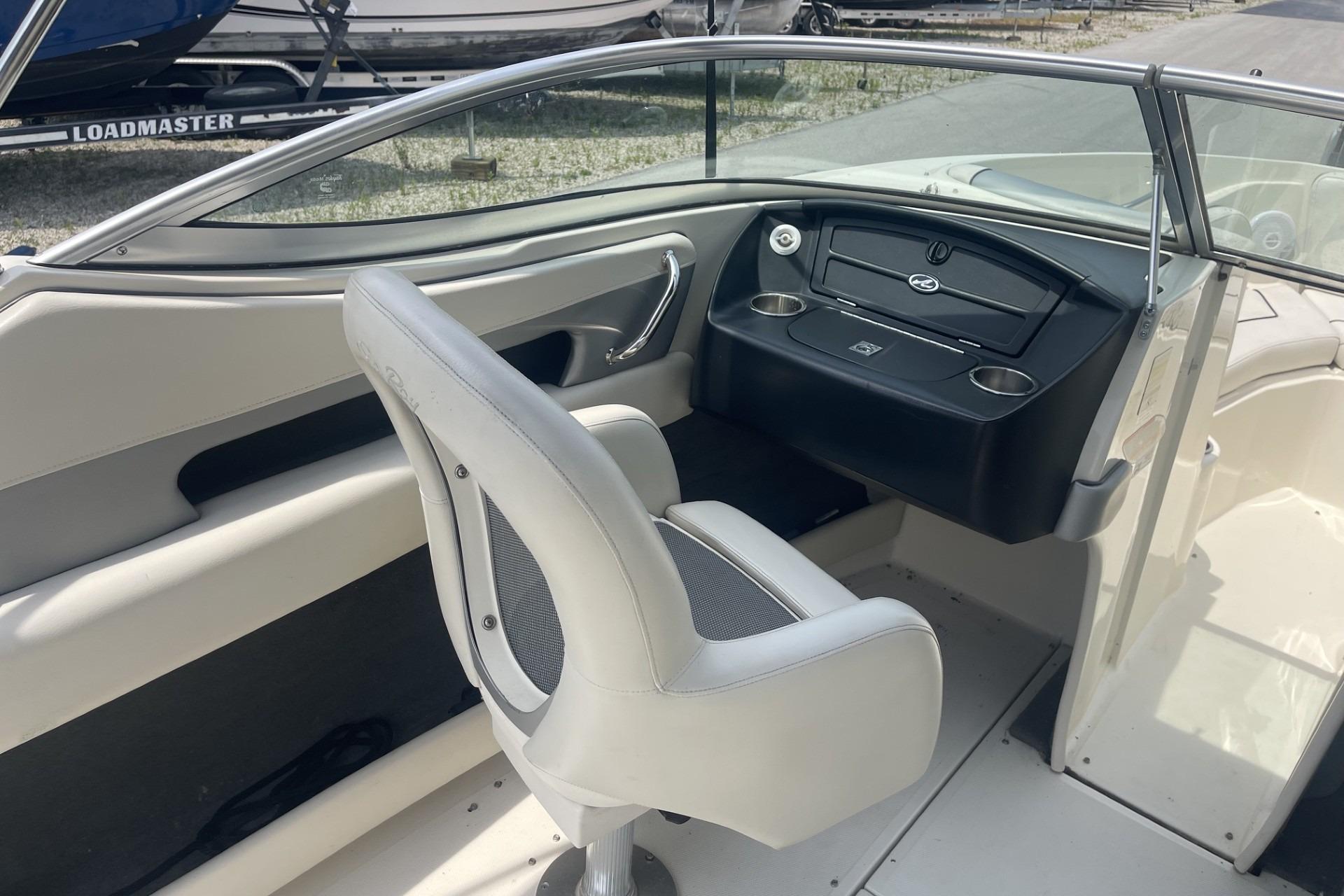 Interior view of a 2010 Sea Ray 230 Bow Rider Select boat, featuring helm and seating.