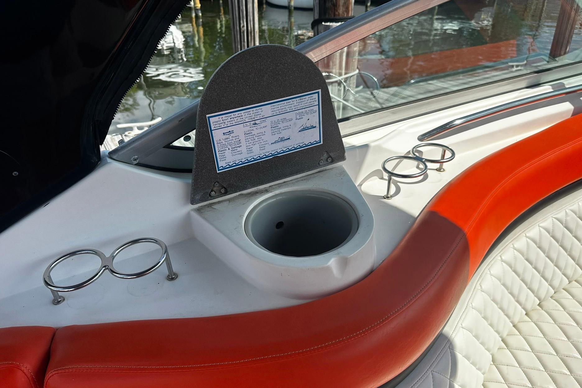 Interior of 2012 Rinker 310 Express Cruiser LE with cup holders and seating.