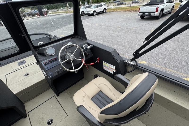 Interior of 2026 SeaArk Predator 300 AK boat, featuring steering wheel and captain's chair.