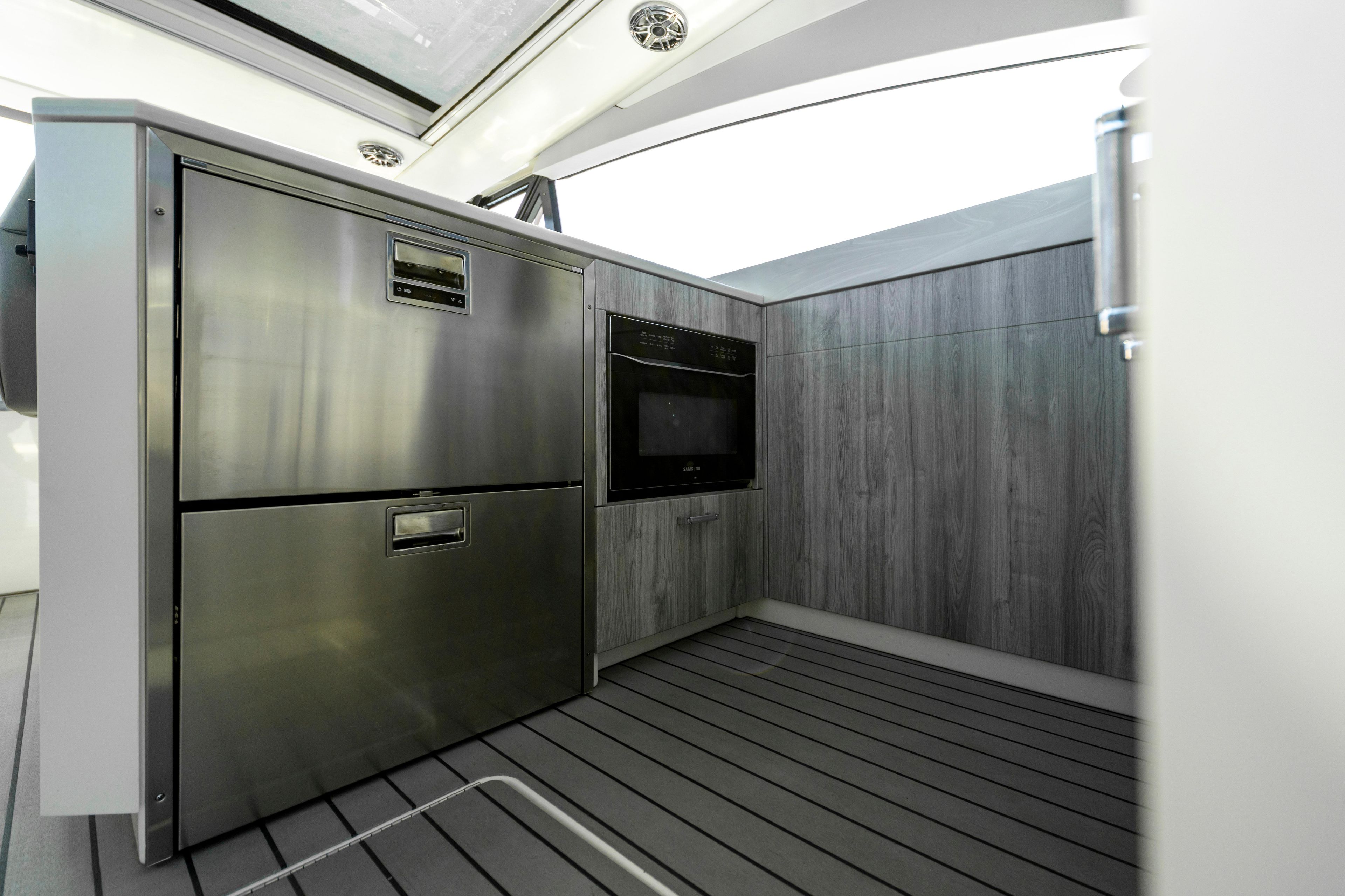 Modern kitchen area in 2022 Formula 500 Super Sport Crossover yacht, featuring stainless steel appliances.