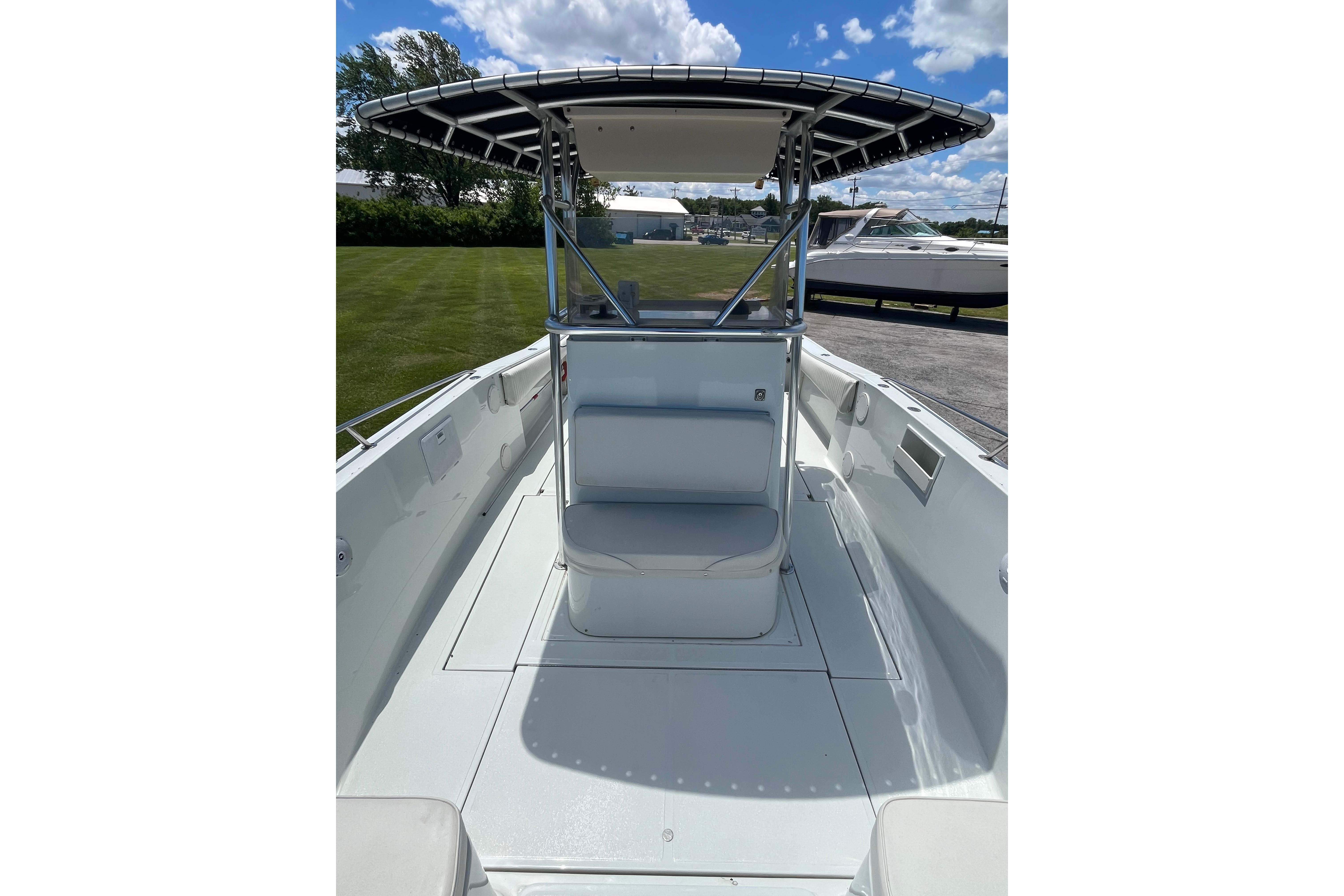 1997 Stamas boat with center console and T-top, docked on a sunny day.