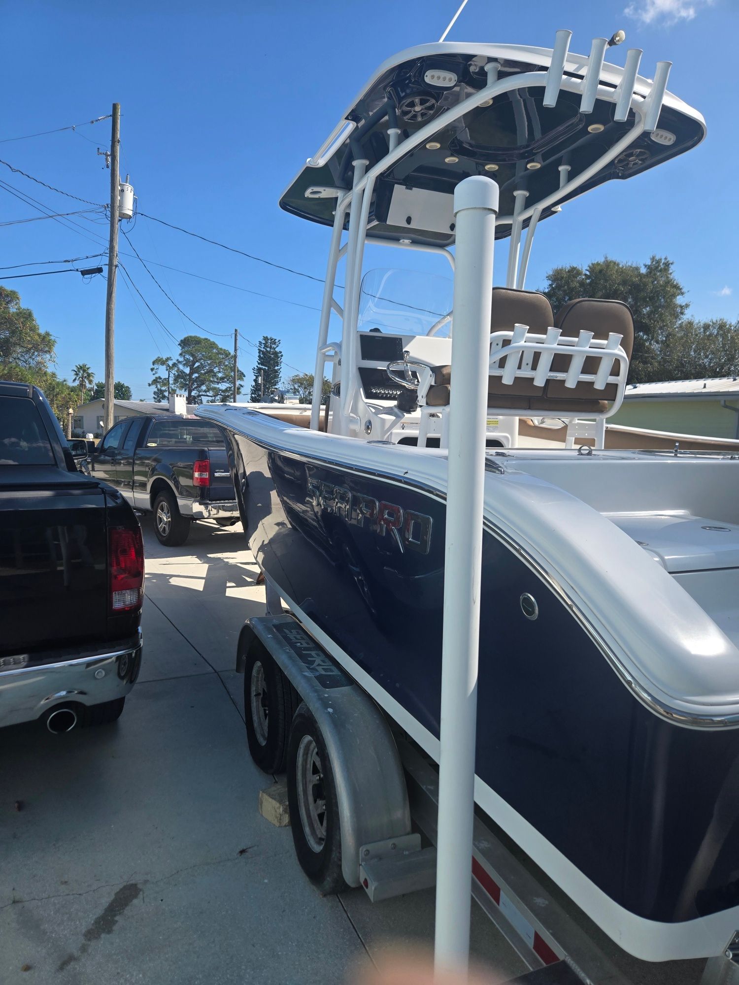 2018 Sea Pro 21.9 boat on trailer, blue hull, sunny day.