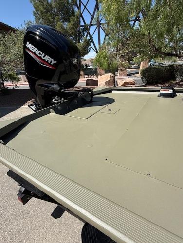 2025 Tracker Grizzly 1860 CC boat with Mercury outboard motor in outdoor setting.