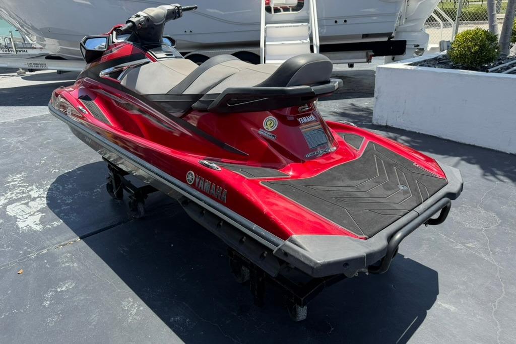 2019 Yamaha VX Limited jet ski in vibrant red, parked outdoors.