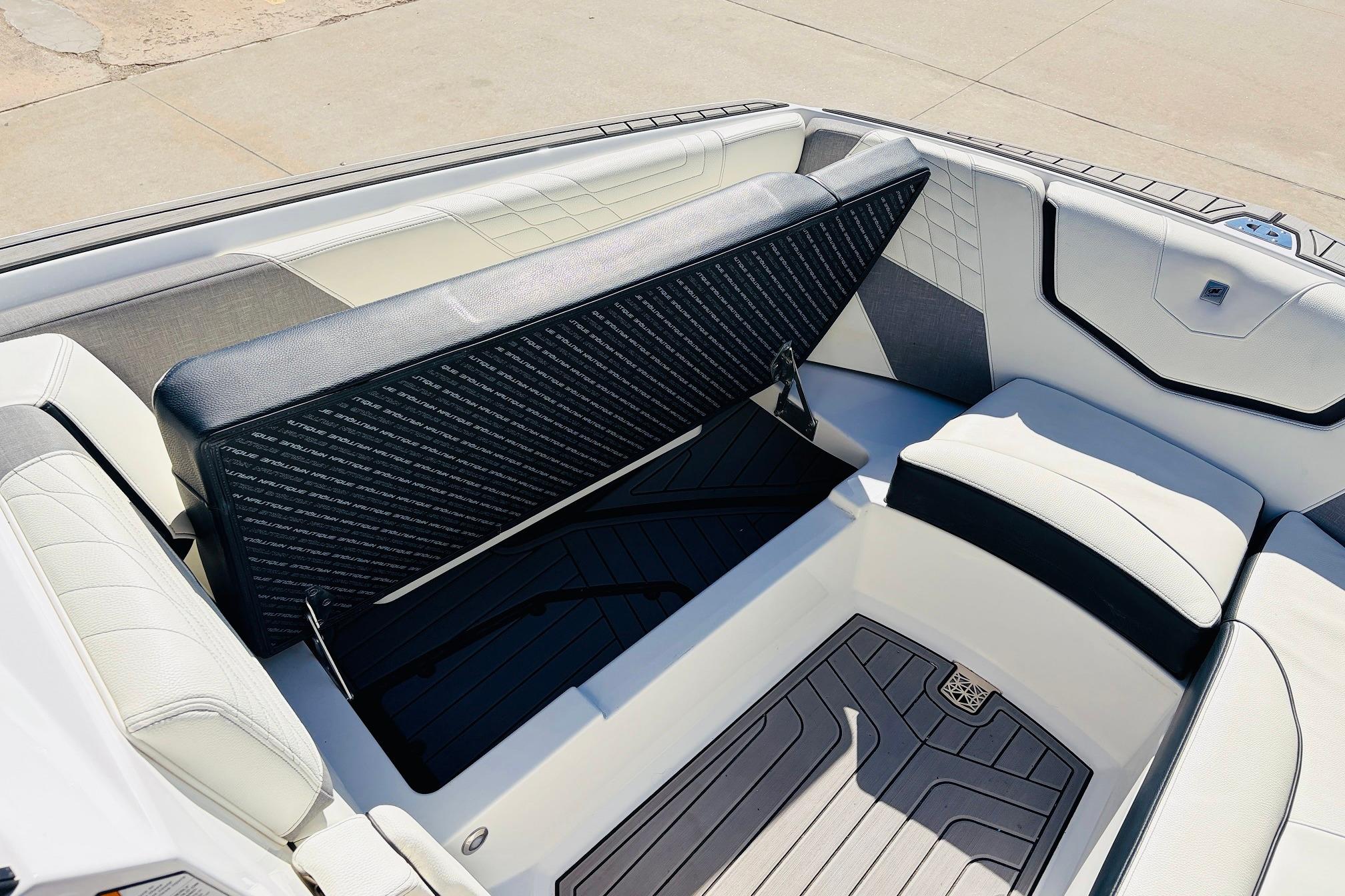 2023 Nautique Super Air Nautique G25 interior seating with storage compartment open.