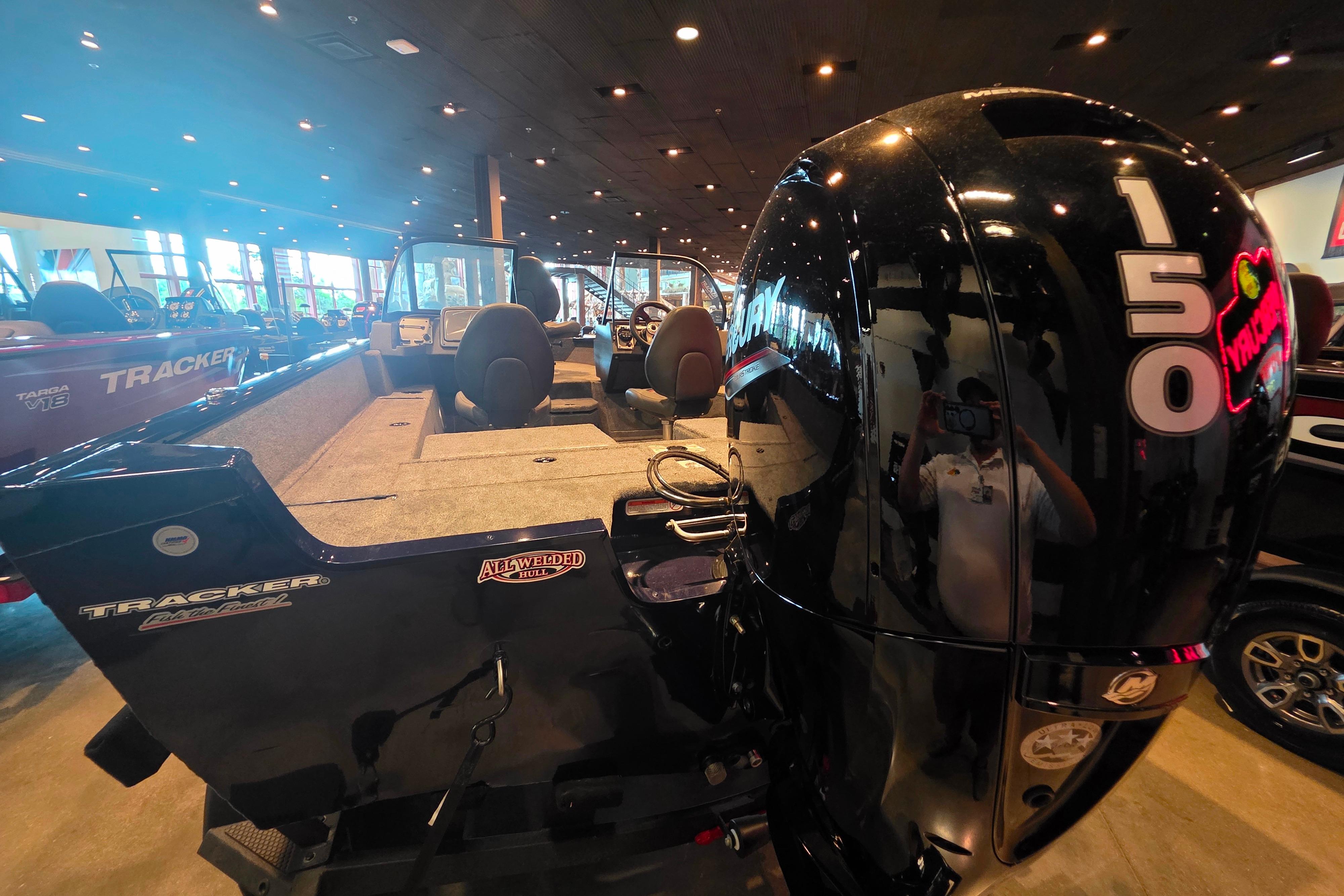 2026 Tracker Pro Guide V-175 Combo boat with powerful 150 HP engine displayed indoors.
