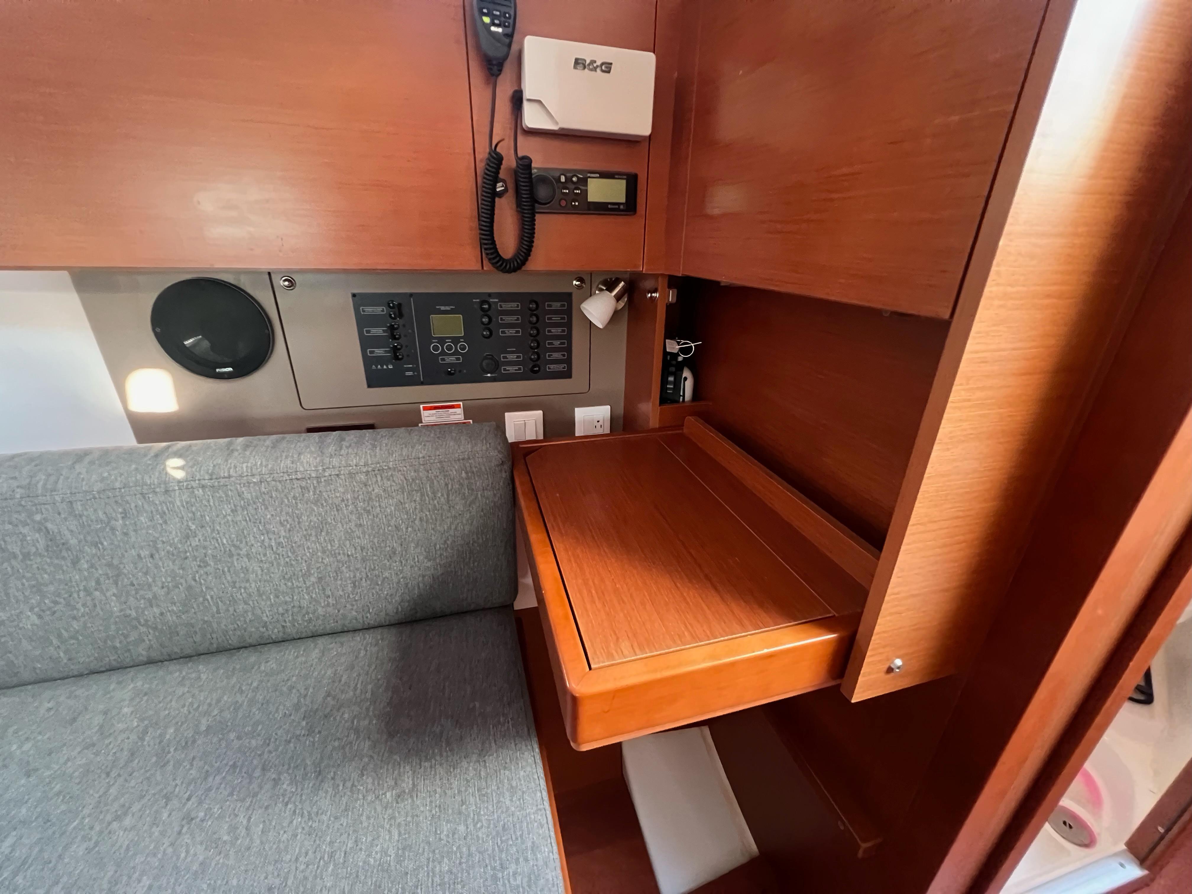 Interior of 2019 Beneteau Oceanis 35.1 yacht with navigation station and seating area.