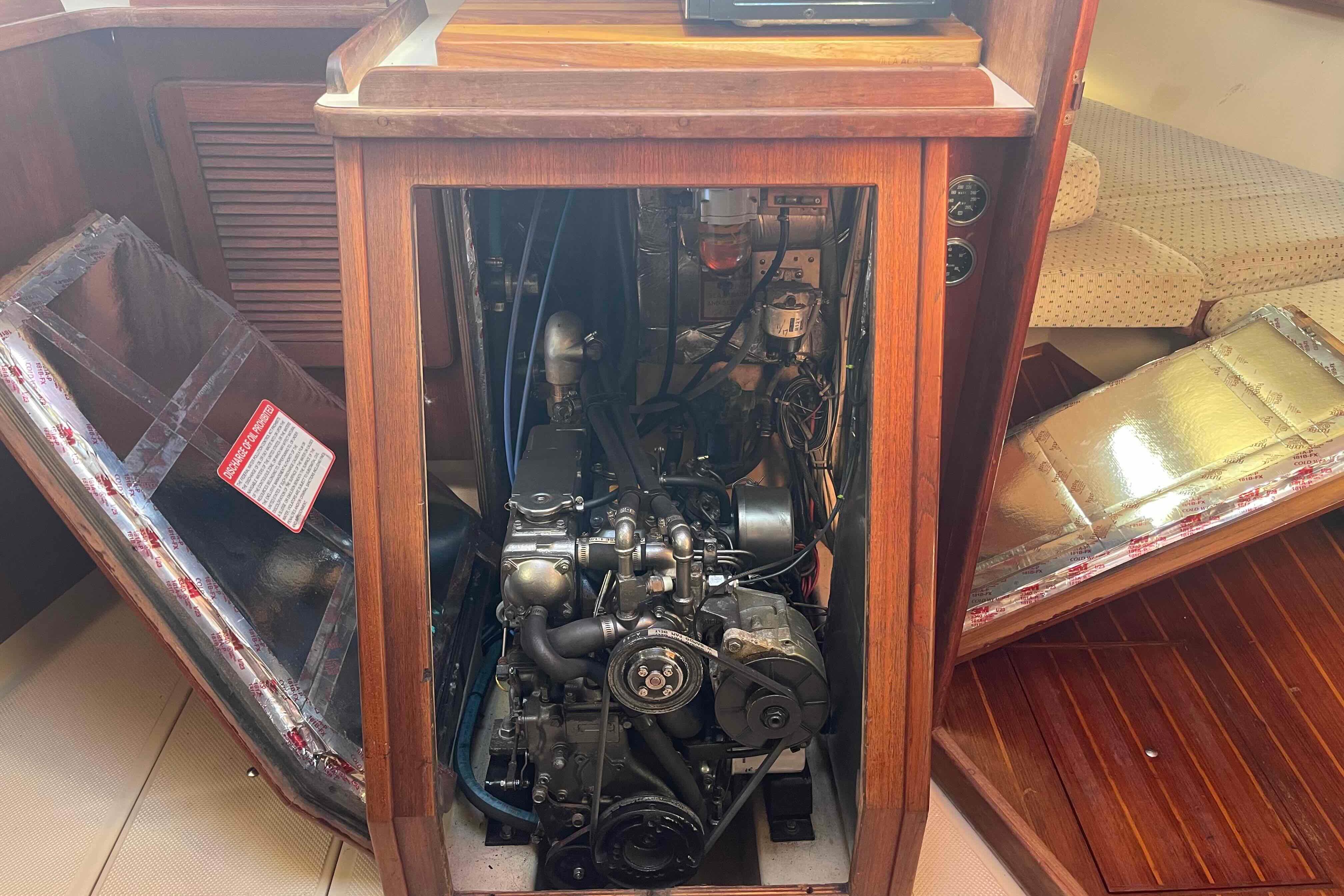 1989 Island Packet 35 sailboat engine compartment with open wooden panels.