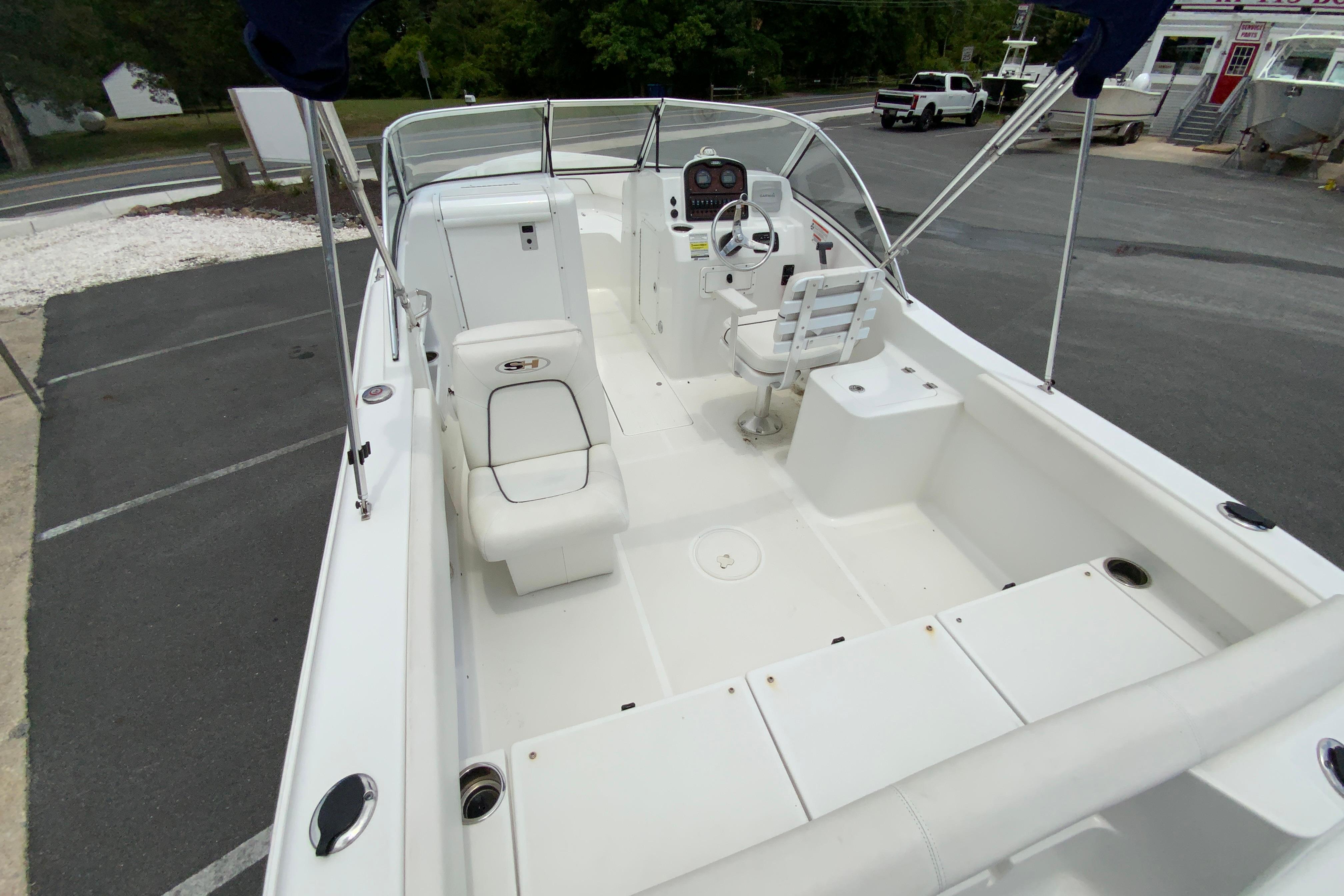 2014 Sea Hunt Escape 211 LE boat interior with seating and steering console.