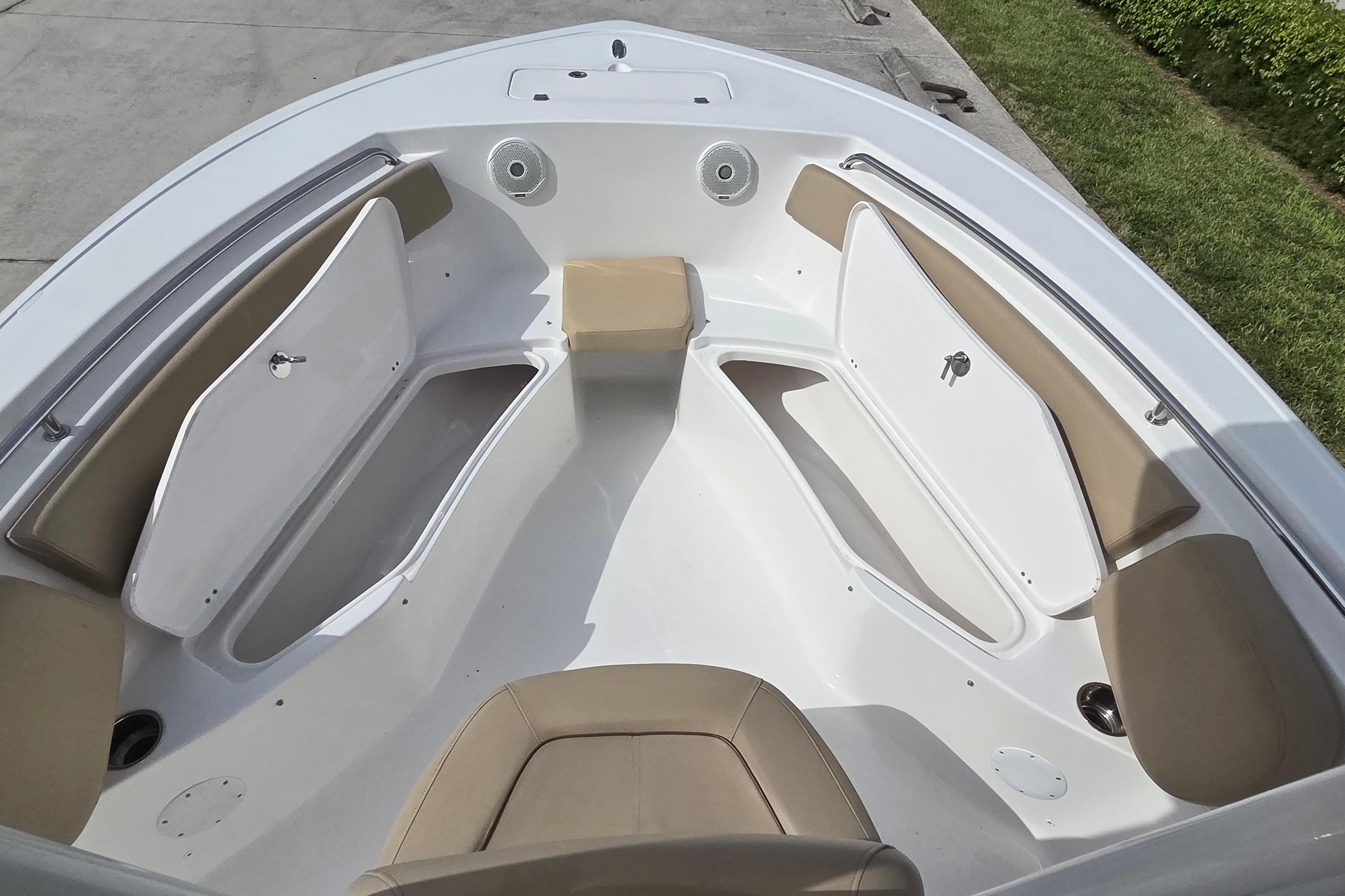 2015 Tidewater 220 LXF boat interior with tan seating and storage compartments.