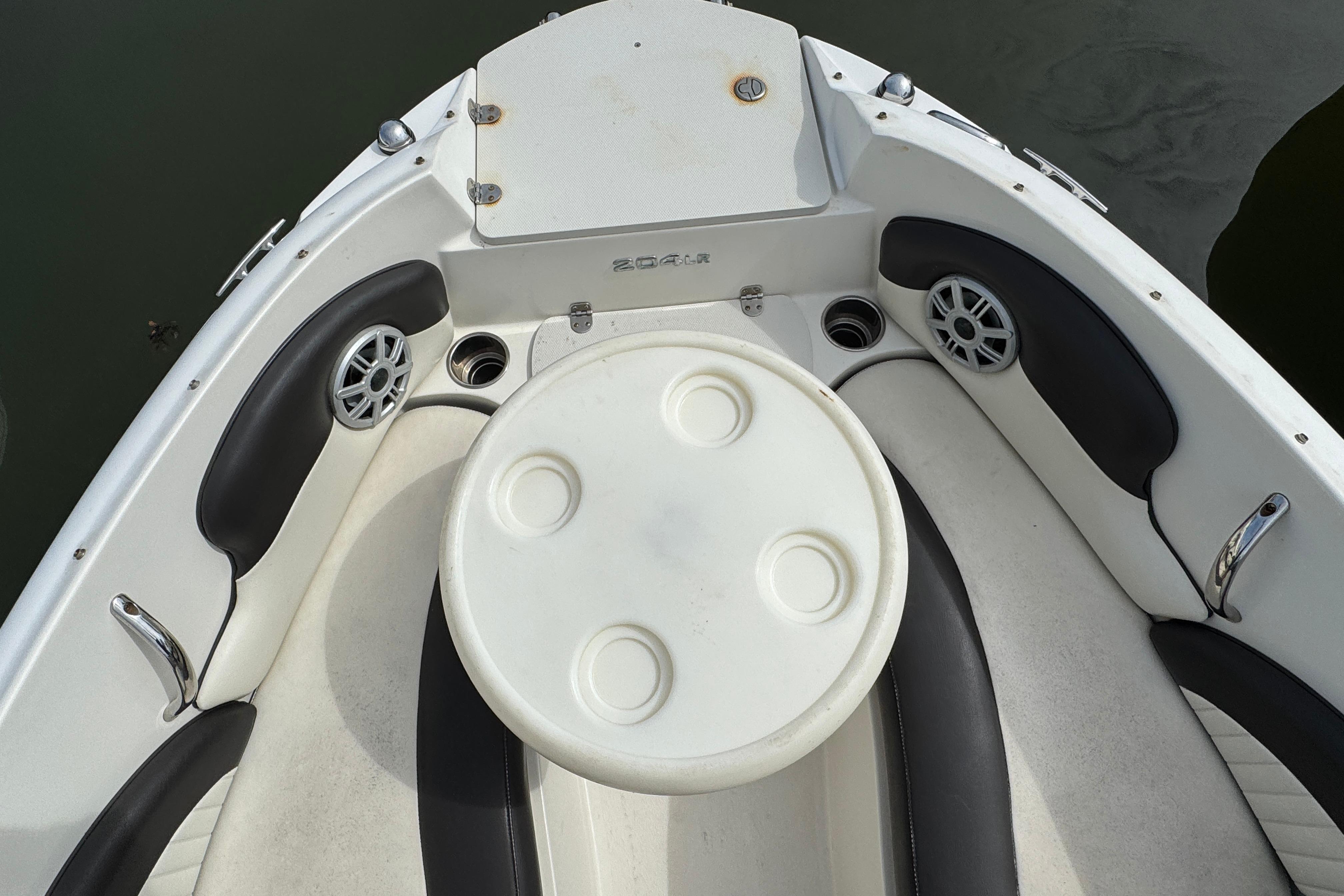 2018 Stingray 204 LR boat interior with seating and round table.