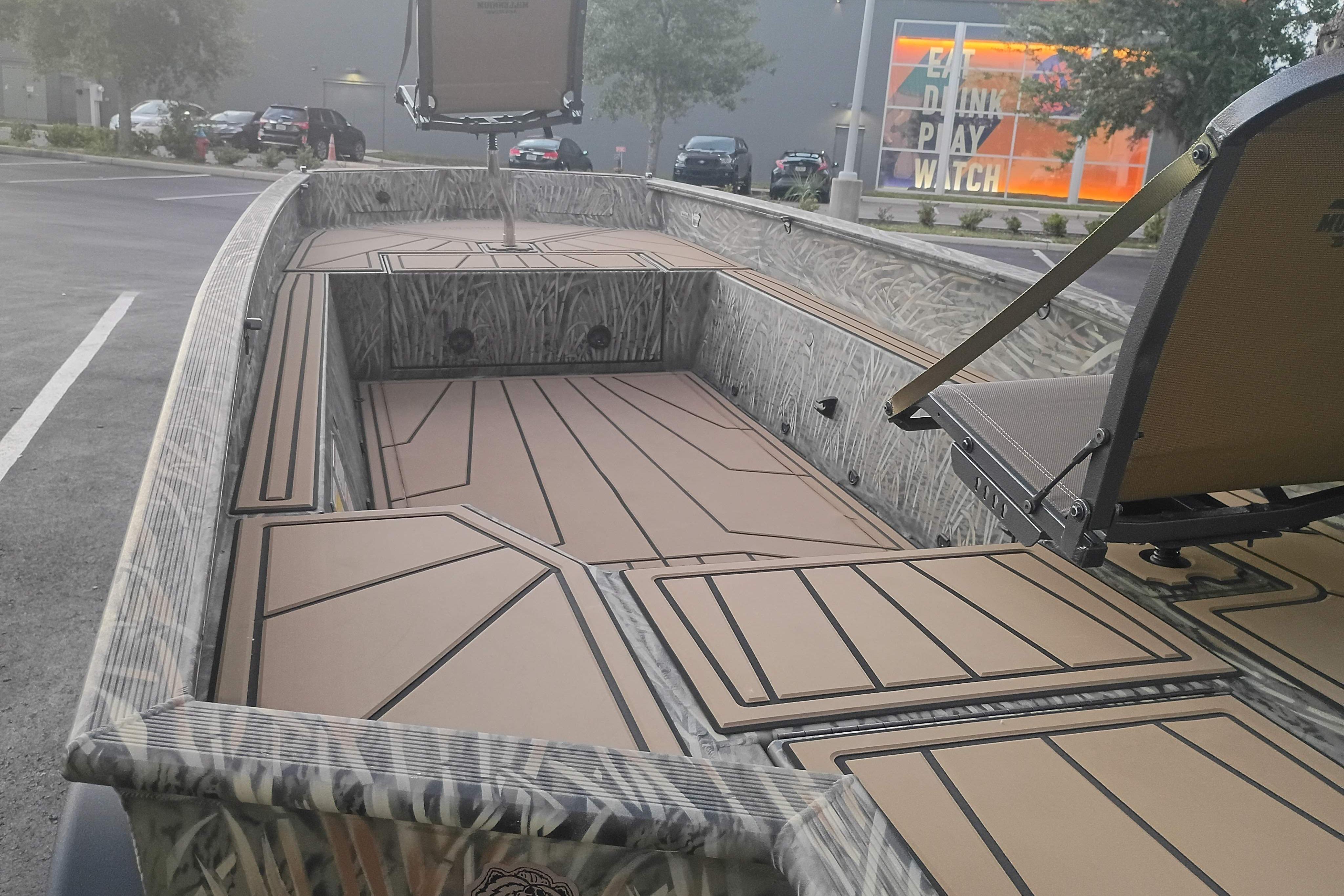2026 Tracker Grizzly 1650 T Prairie Wings Edition boat with camo design in parking lot.