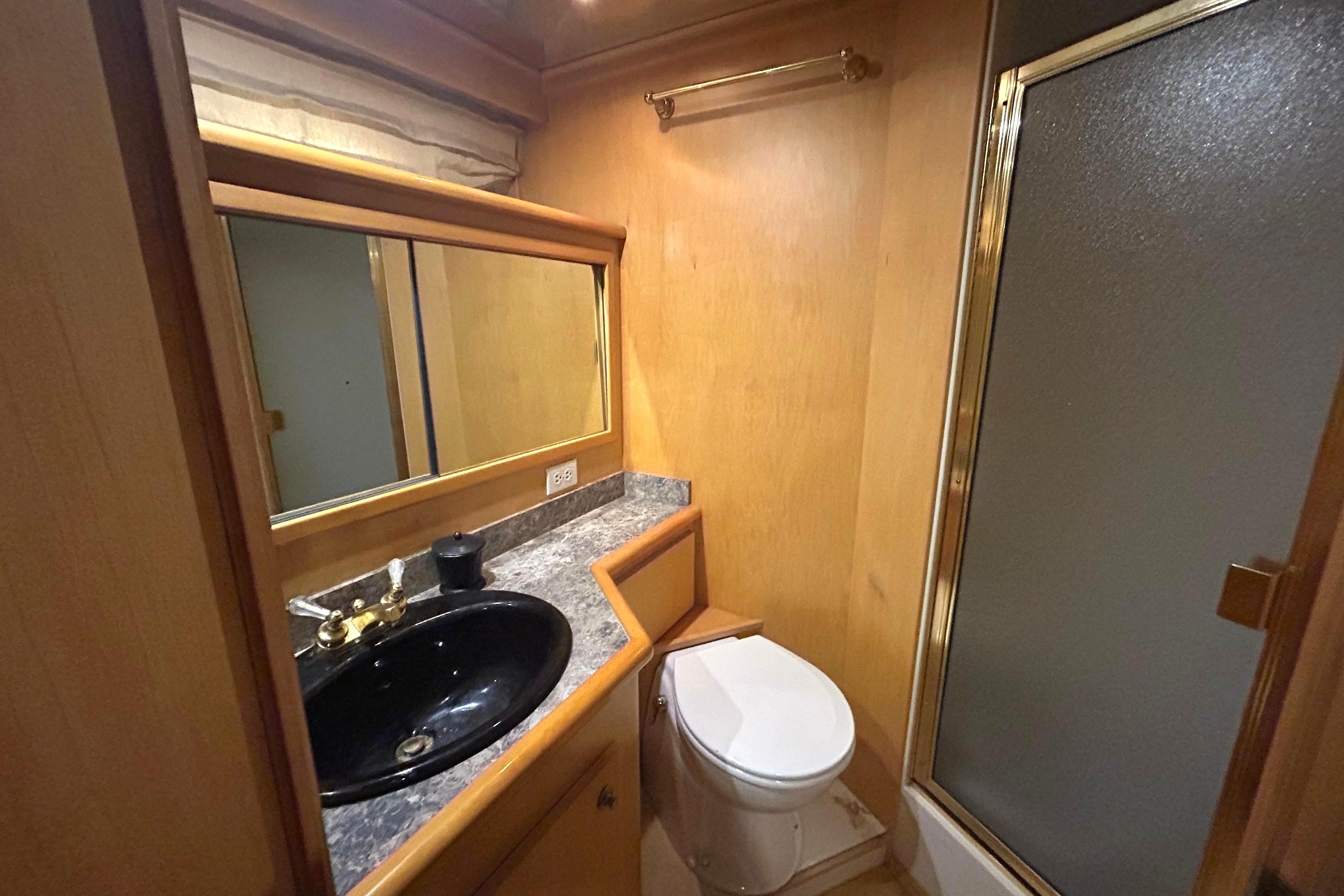 Bathroom interior of 1996 Navigator 53 Classic yacht with sink, toilet, and shower.