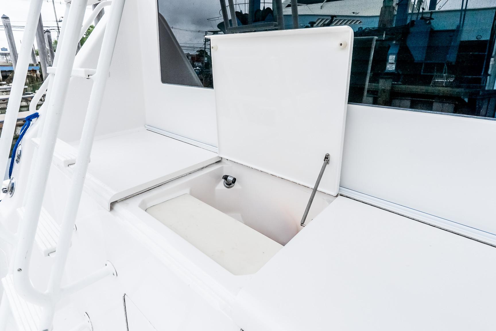 Open storage compartment on a 2000 Viking 50' Convertible yacht deck.