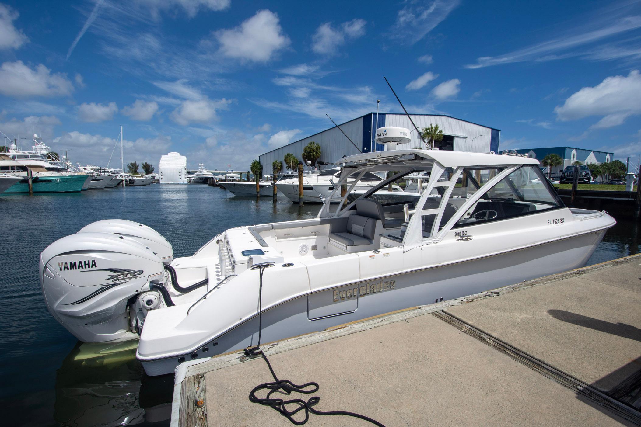 2019 Everglades 340 Dual Console boat docked, featuring Yamaha engines under a clear blue sky.
