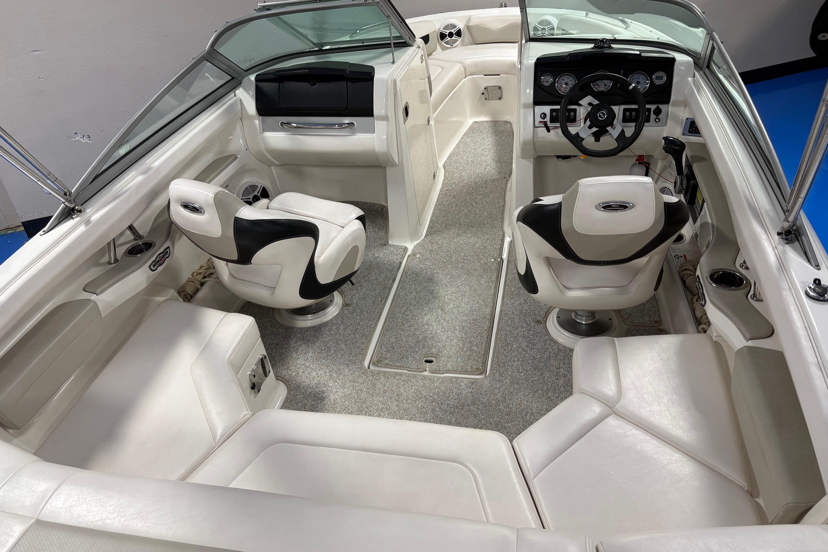 2011 Chaparral 216 SSi boat interior with white seating and modern dashboard.
