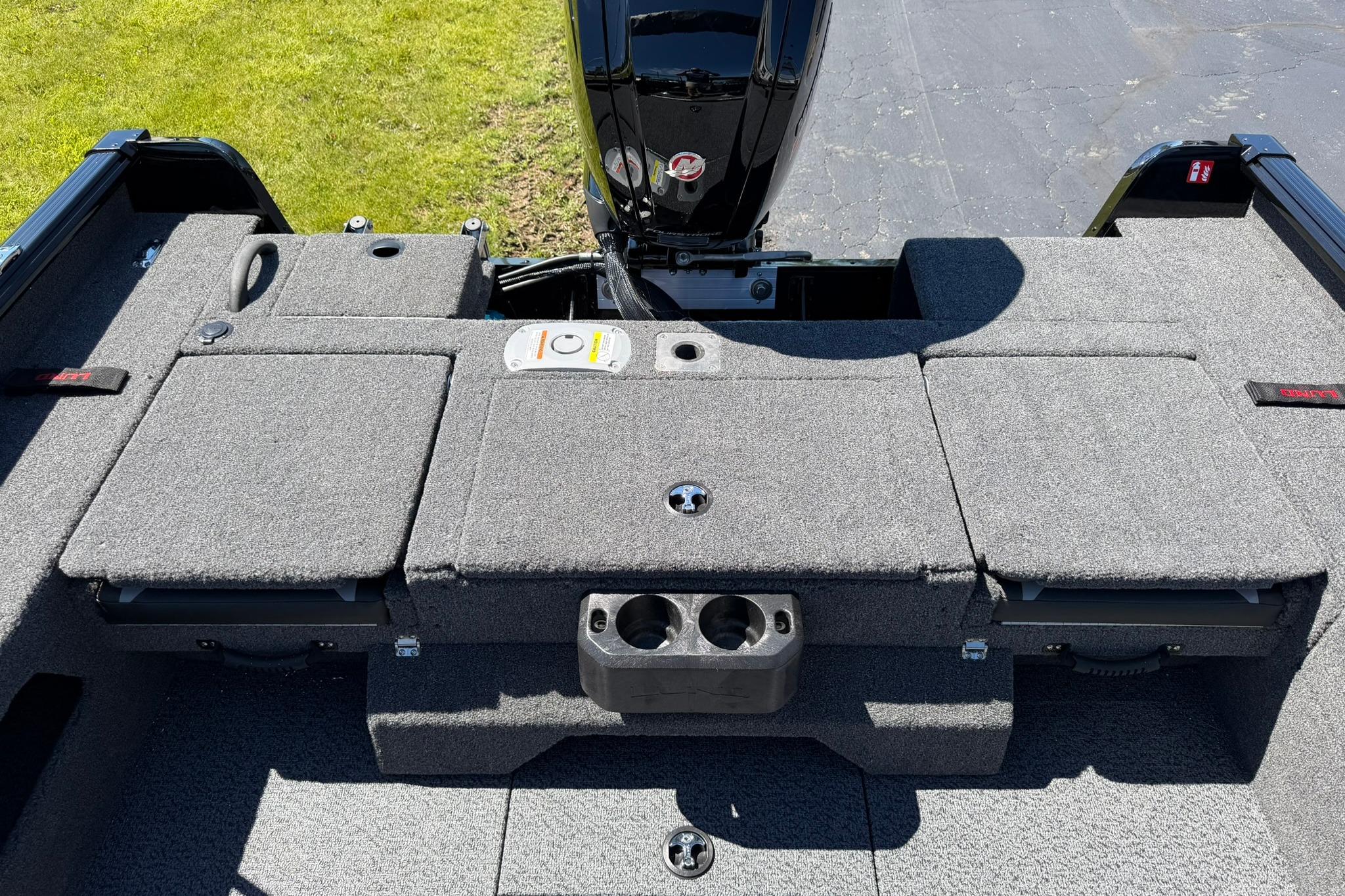 2027 Lund 1775 Impact XS Sport boat interior with carpeted deck and motor.