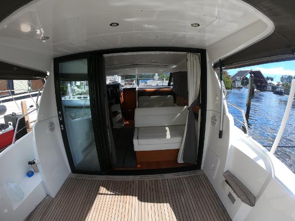 2017 Jeanneau NC 11 boat interior with sliding glass doors and waterfront view.