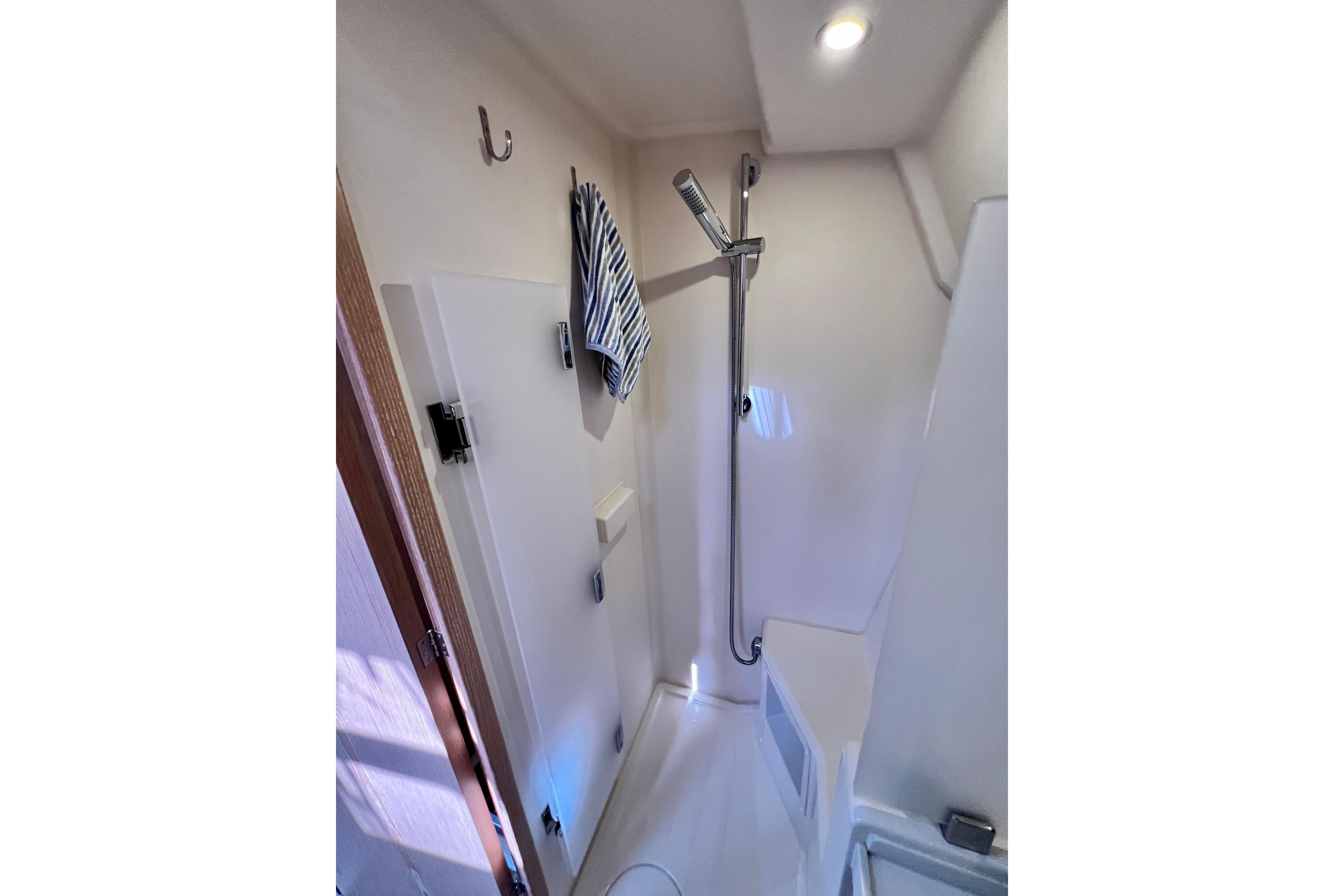 Bathroom interior of 2016 Hanse 455 yacht with shower and towel hook.