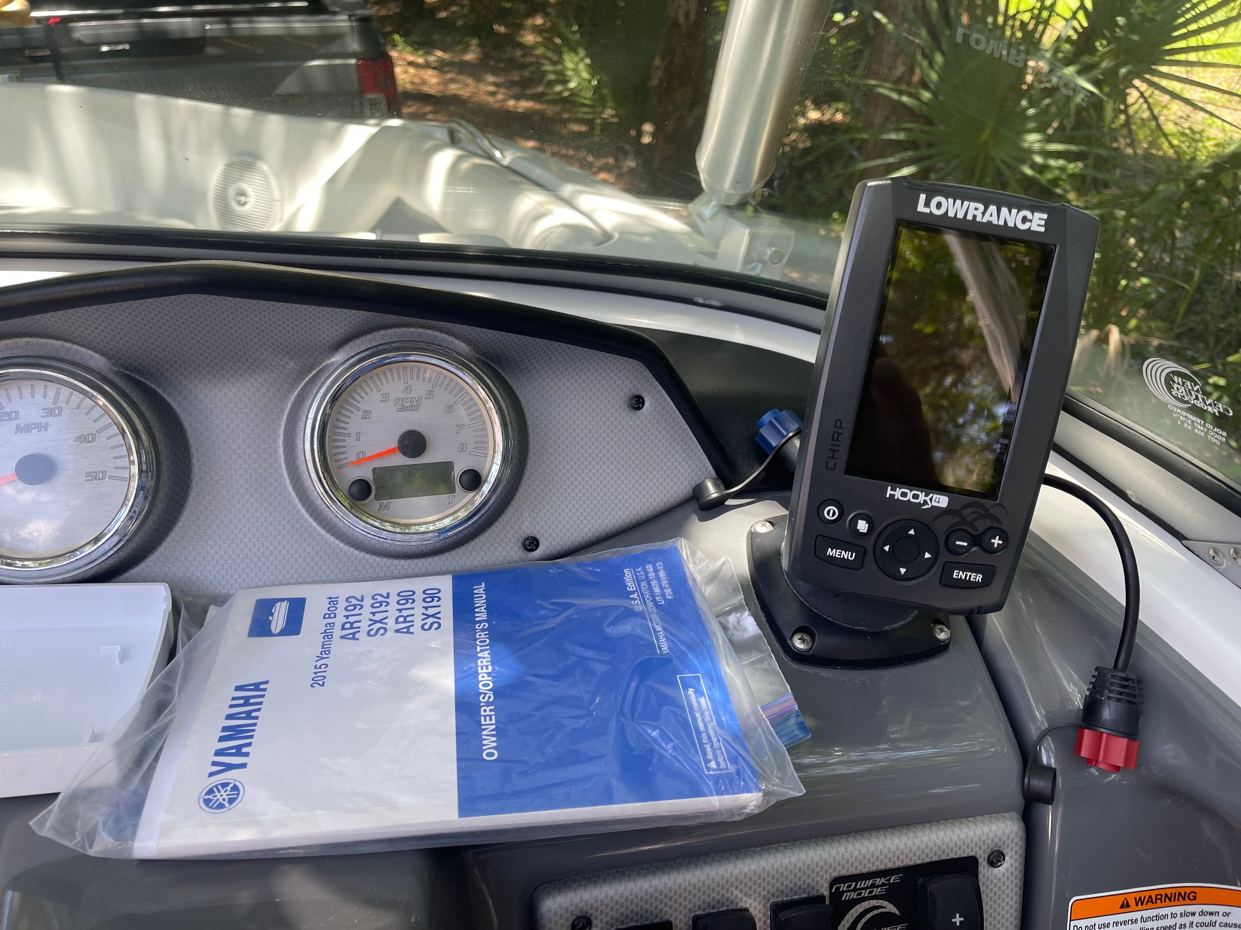 The dashboard of a 2015 Yamaha SX190 boat with a Lowrance GPS device.