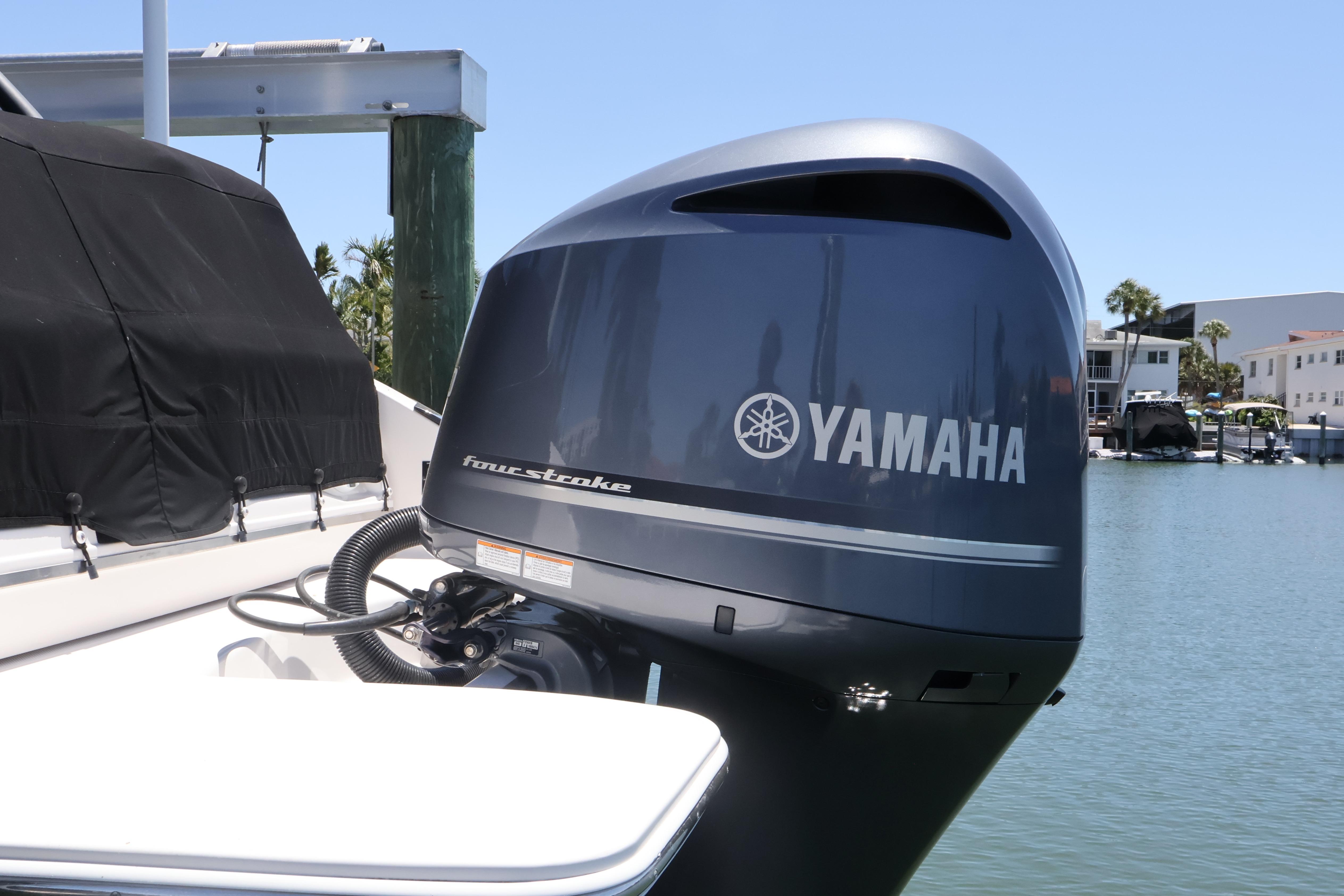 Yamaha four-stroke outboard motor on a 2020 Regal LX4 boat docked by the water.