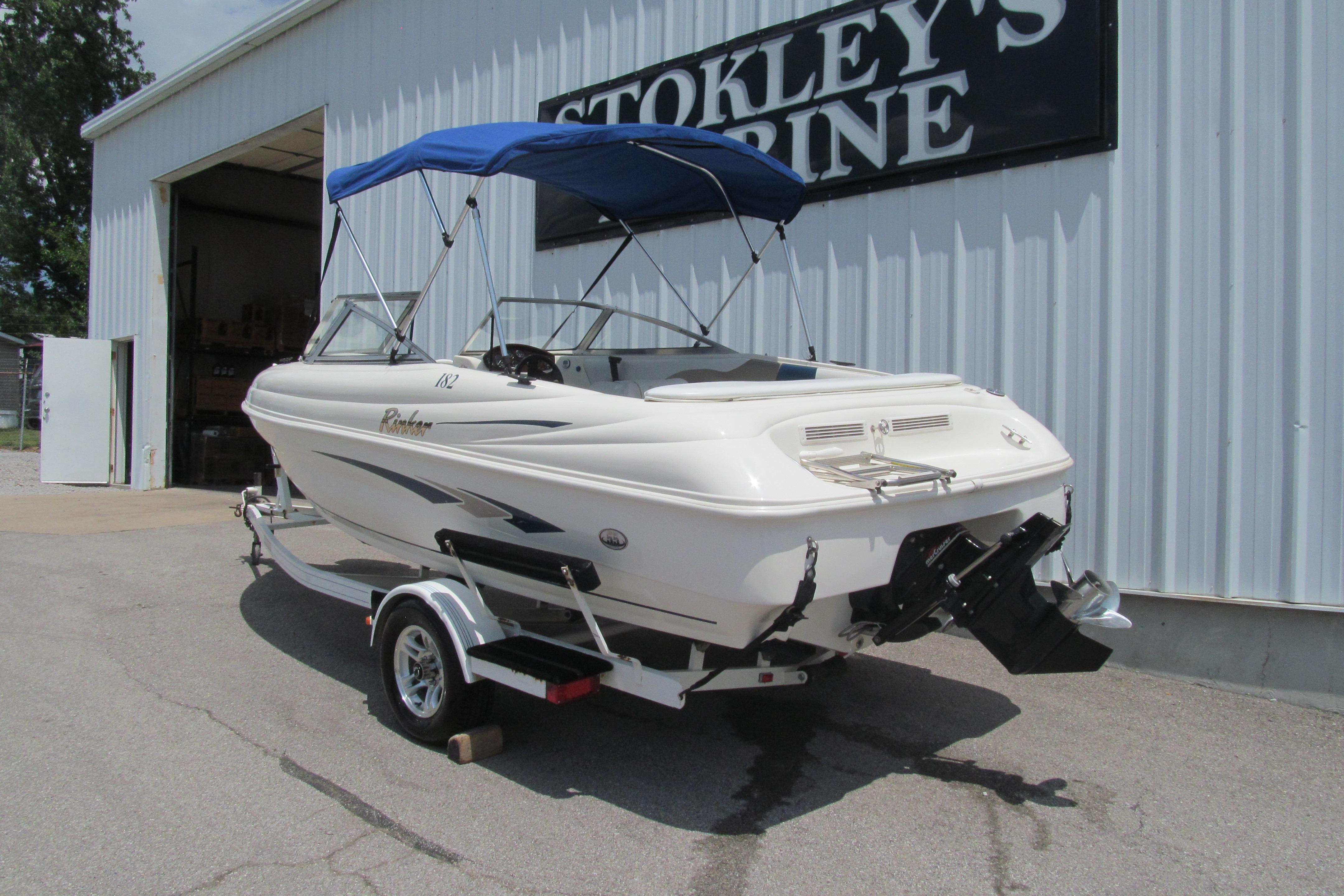 2000 Rinker boat with blue canopy on trailer at Stokley's Marine.