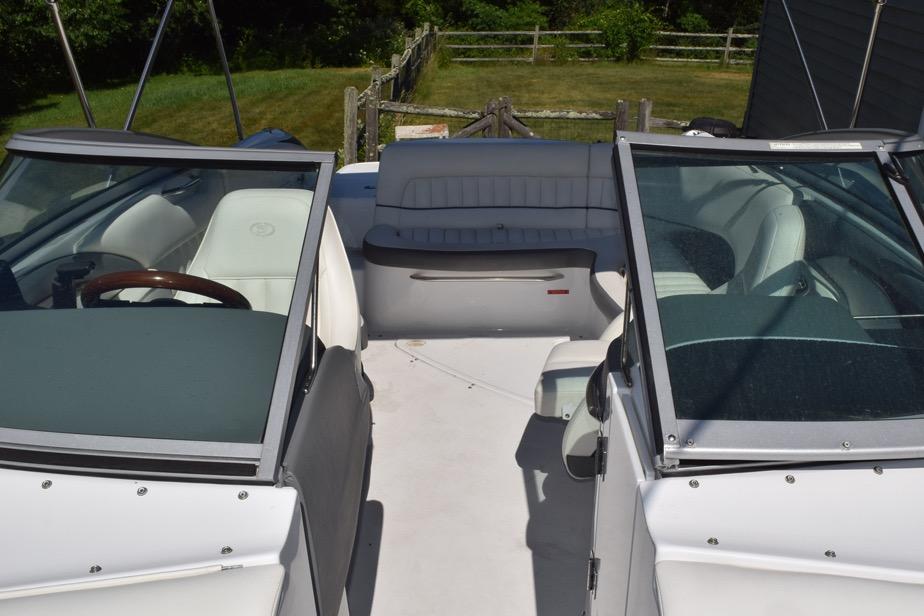 2006 Cobalt 240 boat interior with white seating and dual windshields.