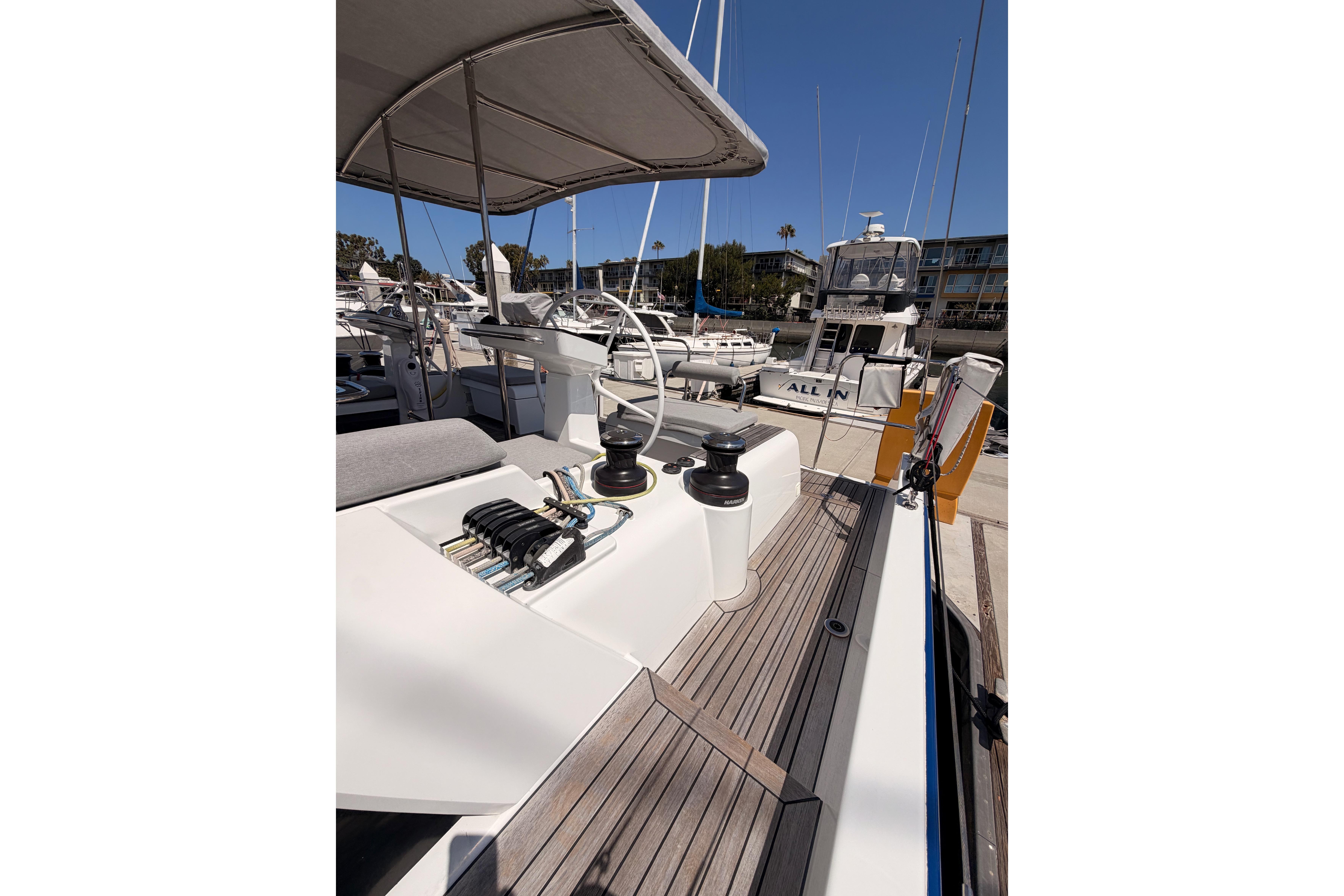 2022 Beneteau Oceanis Yacht 54 docked, showcasing deck and helm details.