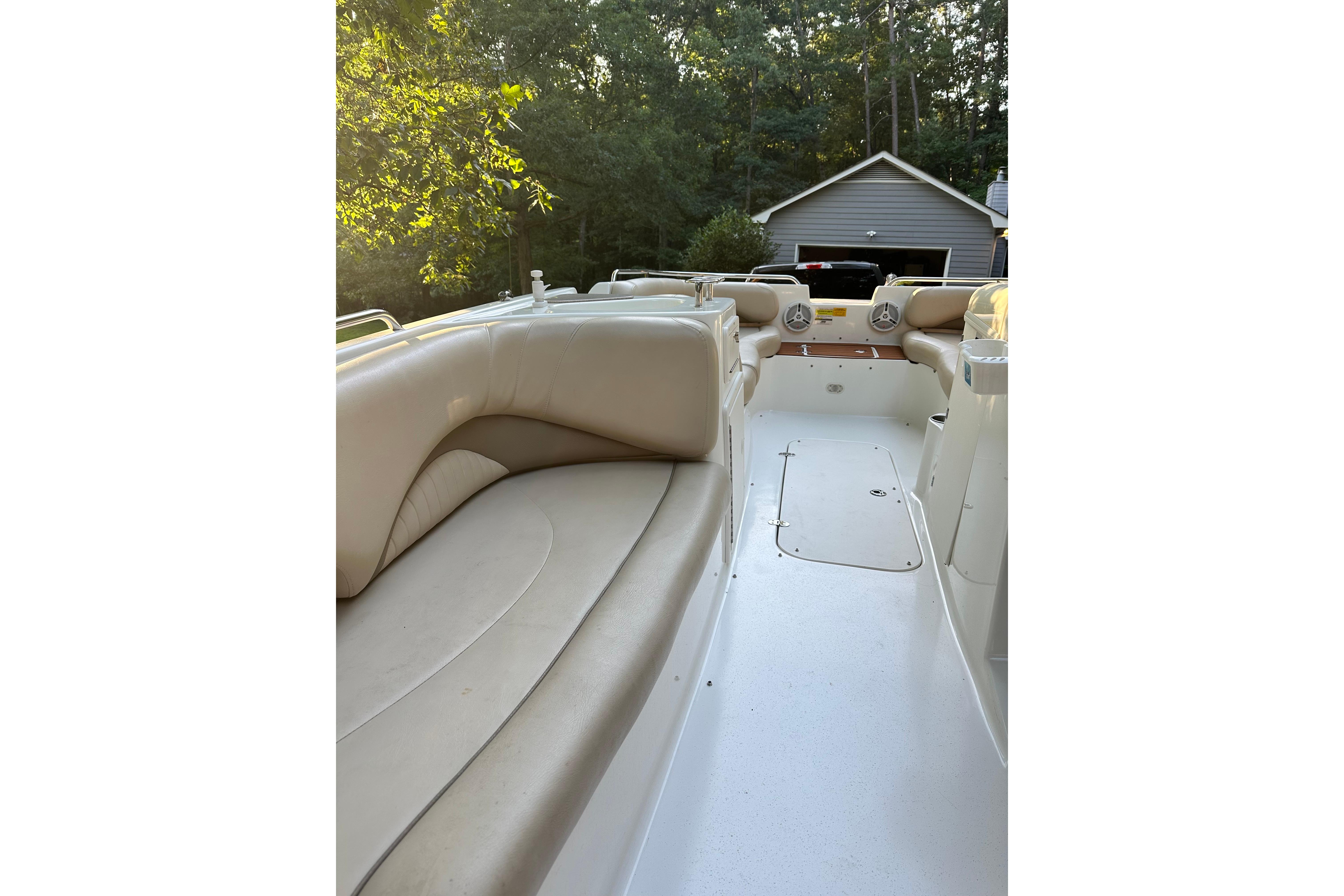 2008 NauticStar 230 SL Sport Deck I/O boat interior with beige seating and outdoor setting.