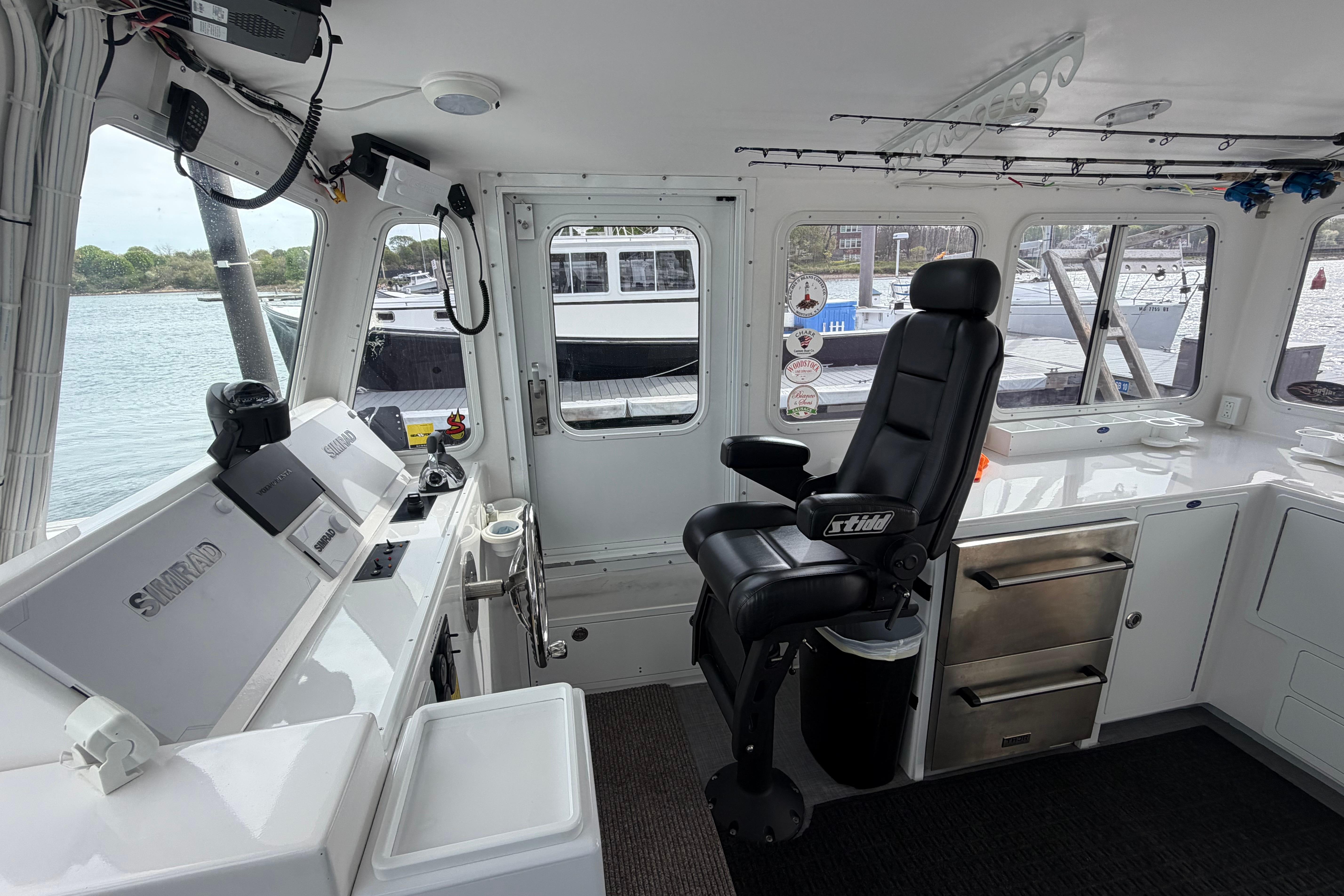 Interior of 2018 H&H Marine Osmond Beal boat with navigation equipment and captain's chair.