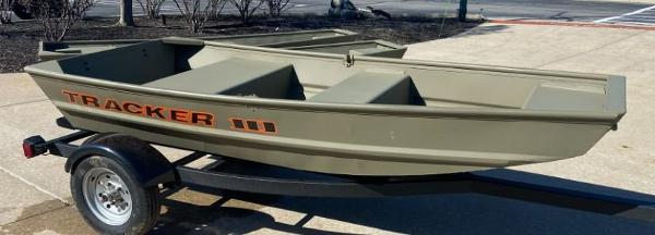 2025 Tracker Grizzly 1036 Utility boat on trailer, parked outdoors.