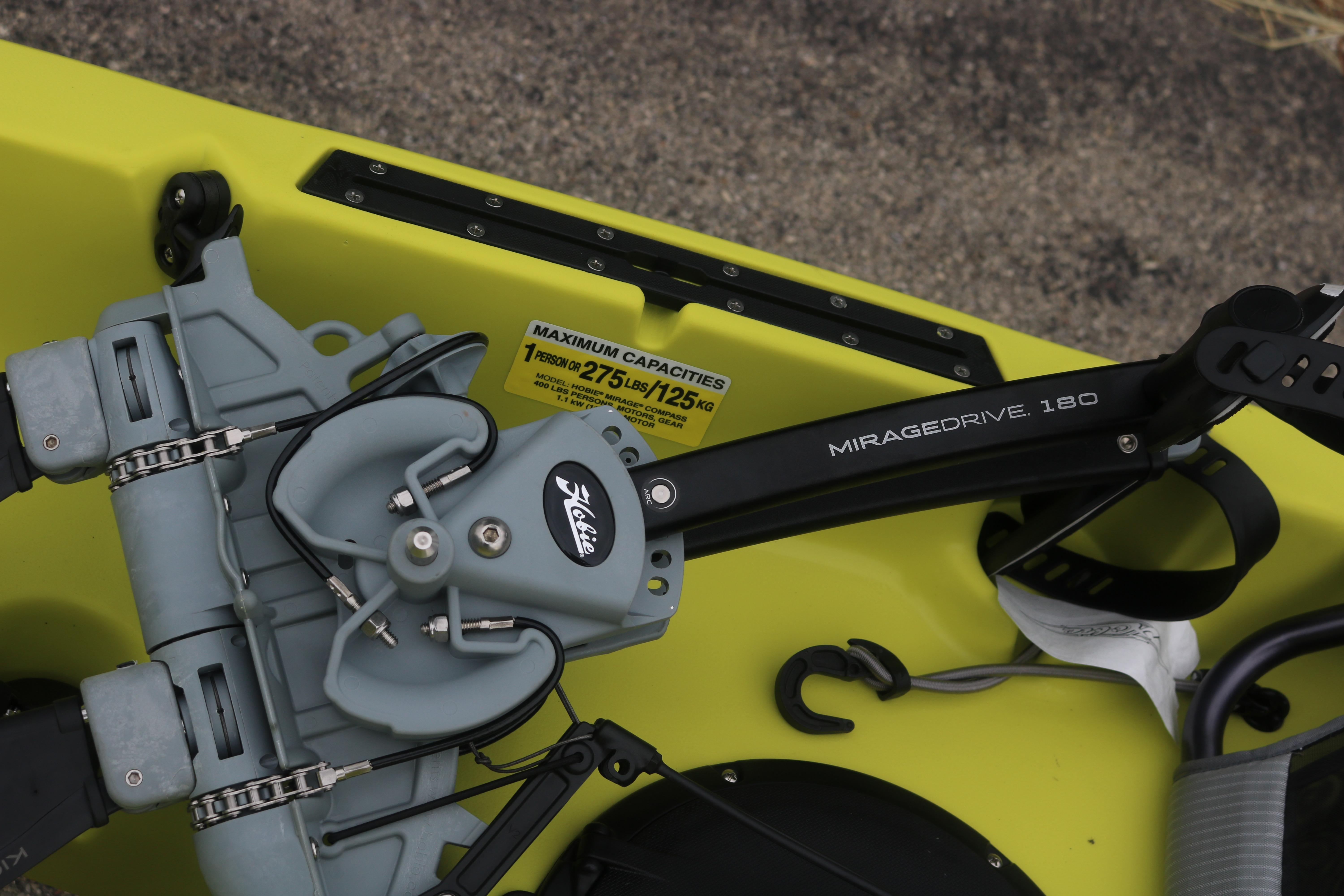 2025 Hobie Mirage Compass kayak with MirageDrive 180 pedal system, yellow hull, capacity label visible.