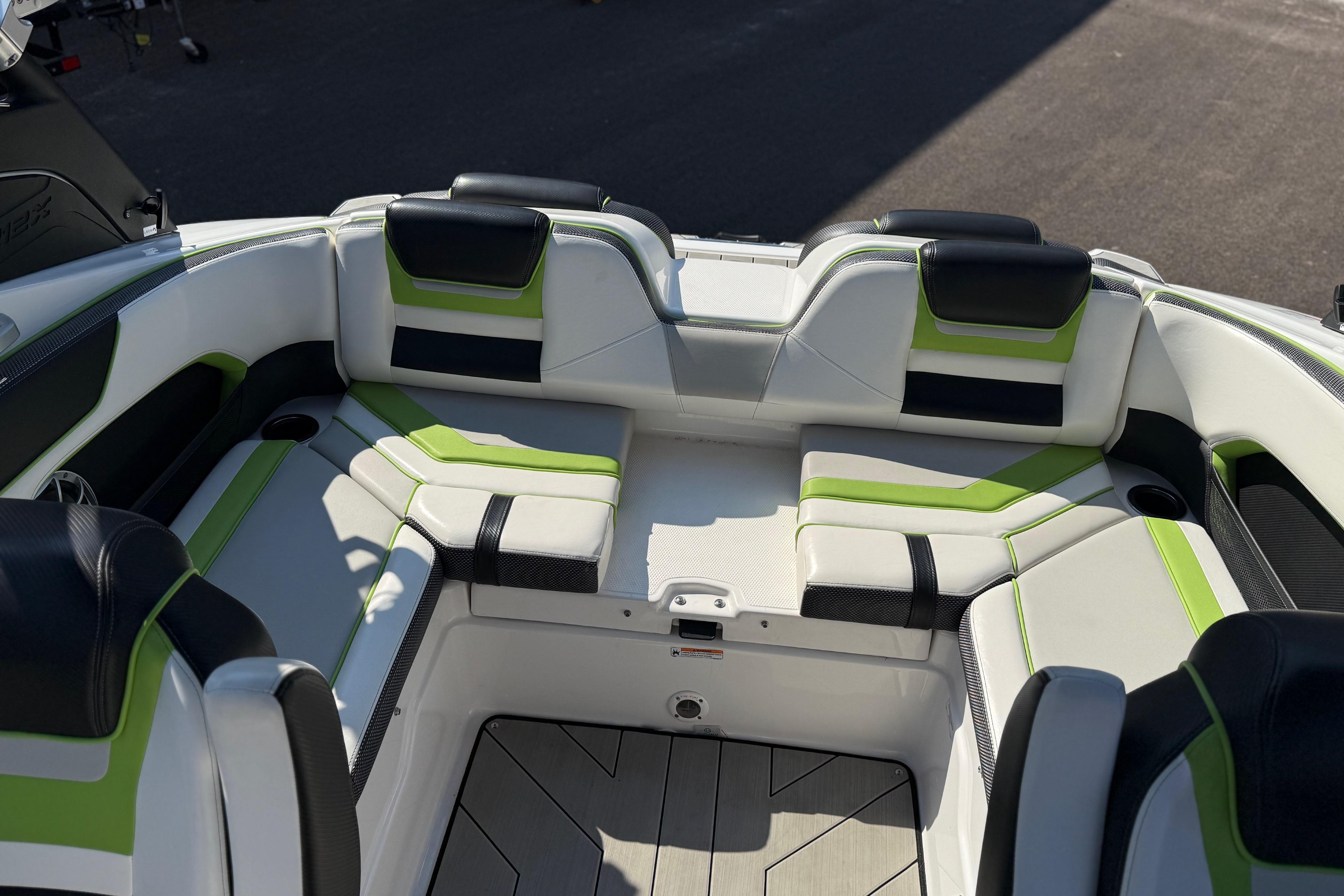 Interior seating of 2022 Yamaha Boats 212XE with green and black accents.