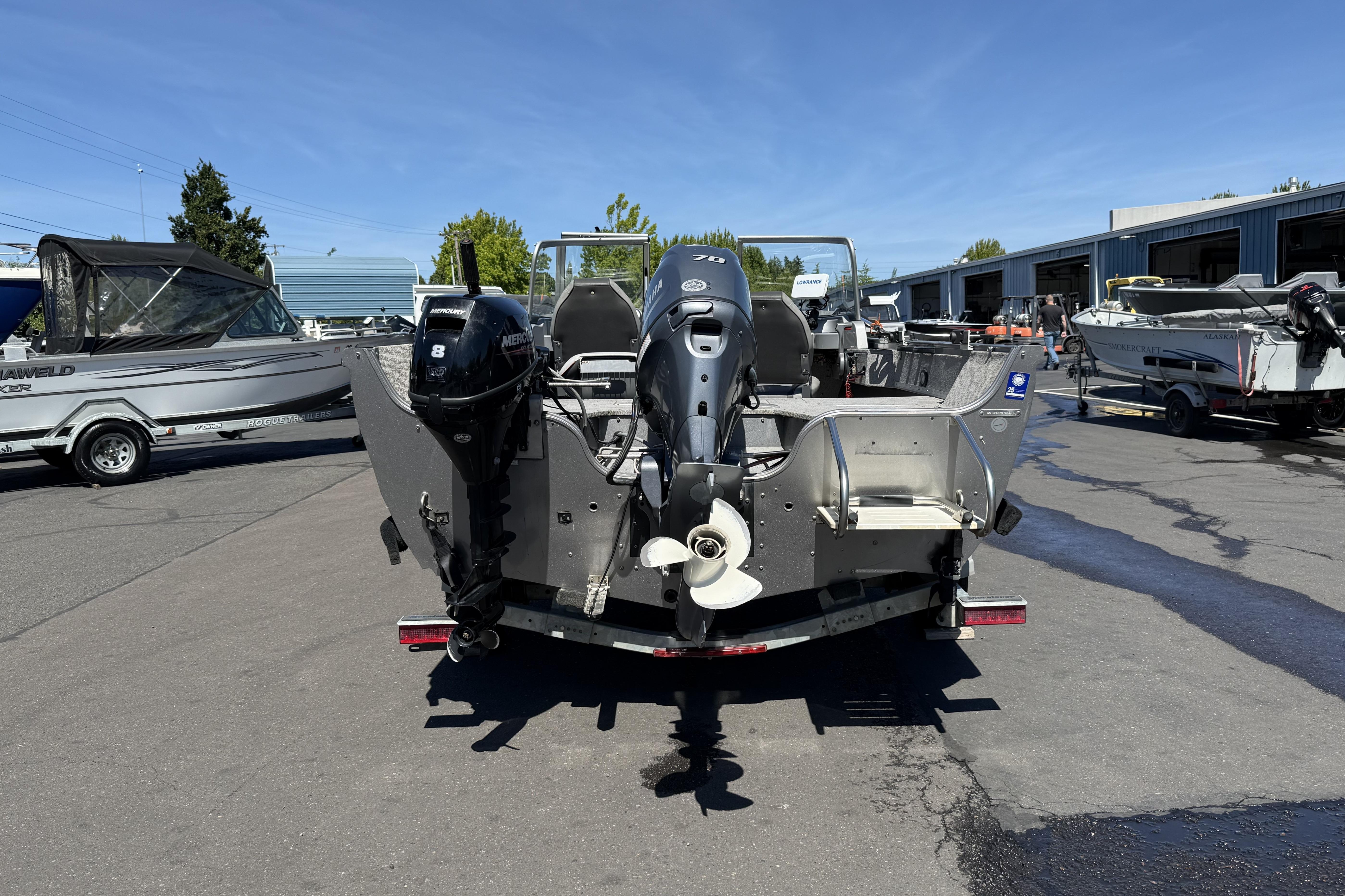2016 Crestliner 1700 Vision boat with dual outboard motors in a marina setting.