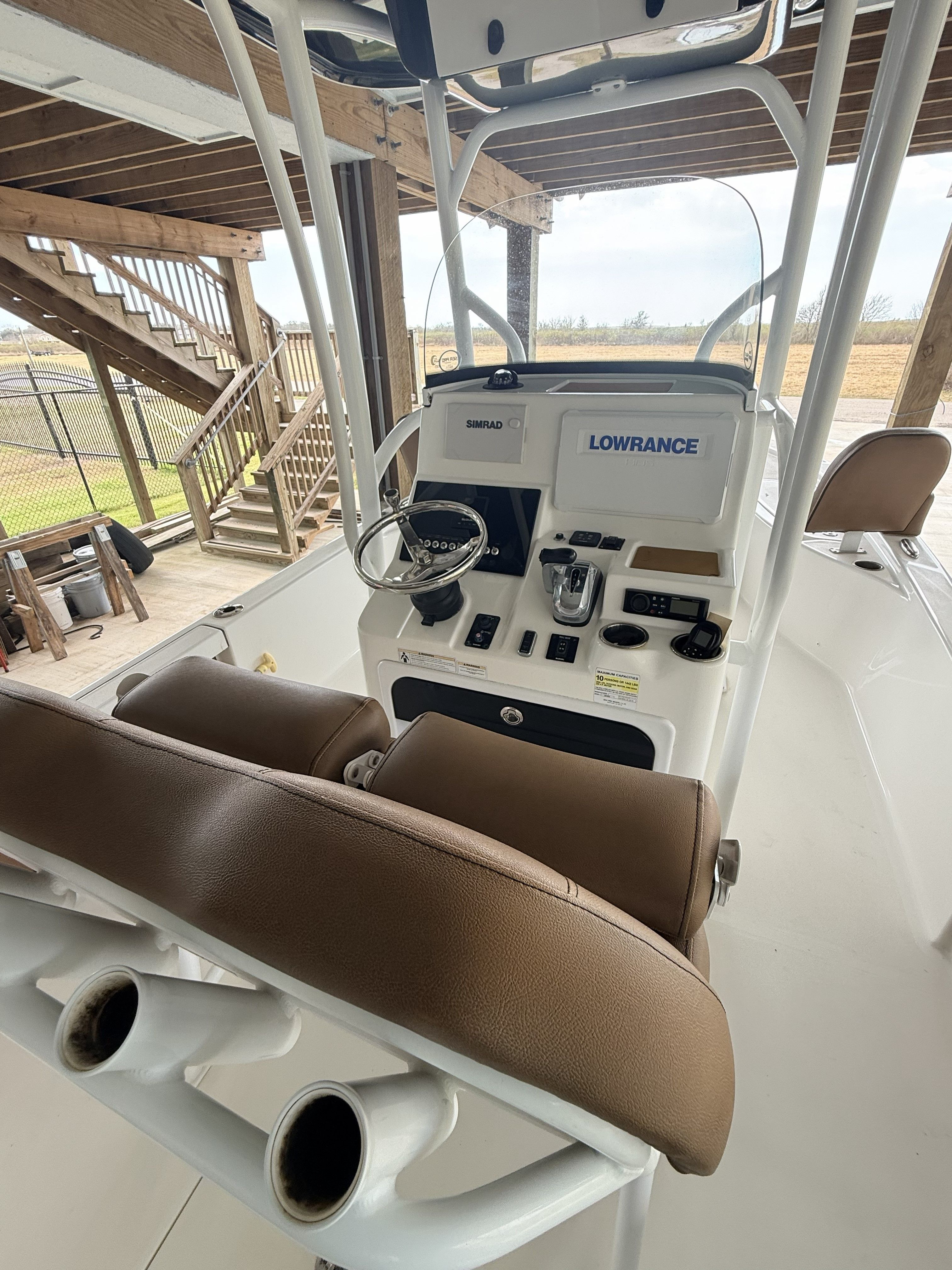 The image shows the cockpit of a Sea Pro 248 Bay boat with controls and electronics.