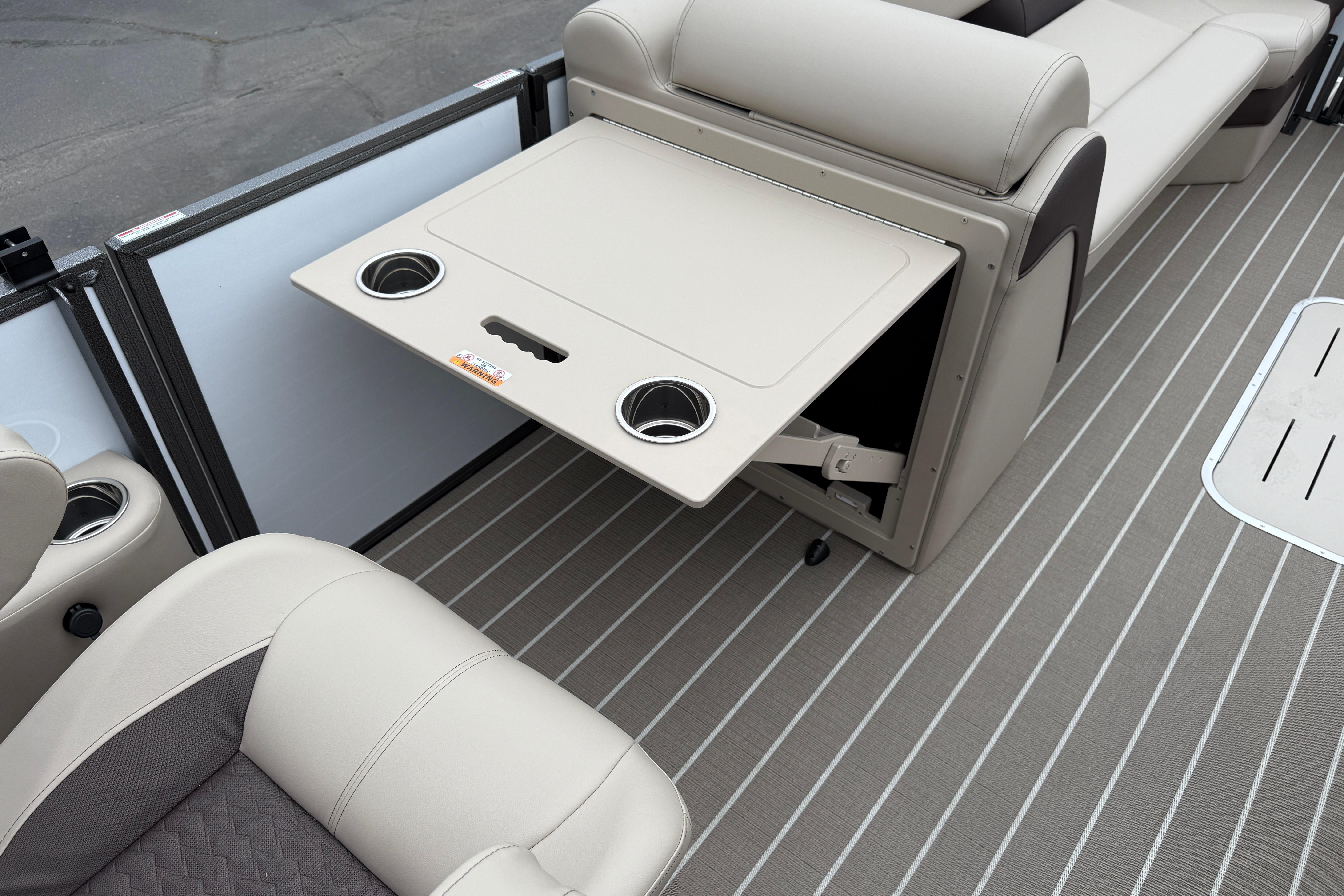 2026 Bentley Pontoons Elite 253 Admiral interior with foldable table and cup holders.