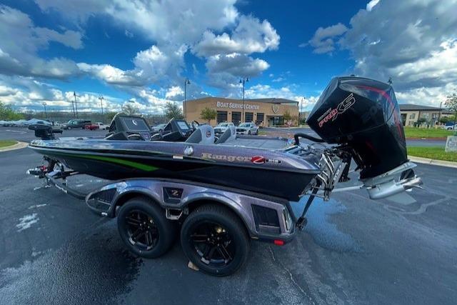 2026 Ranger Z518 Cup-Equipped boat with powerful outboard motor in parking lot.