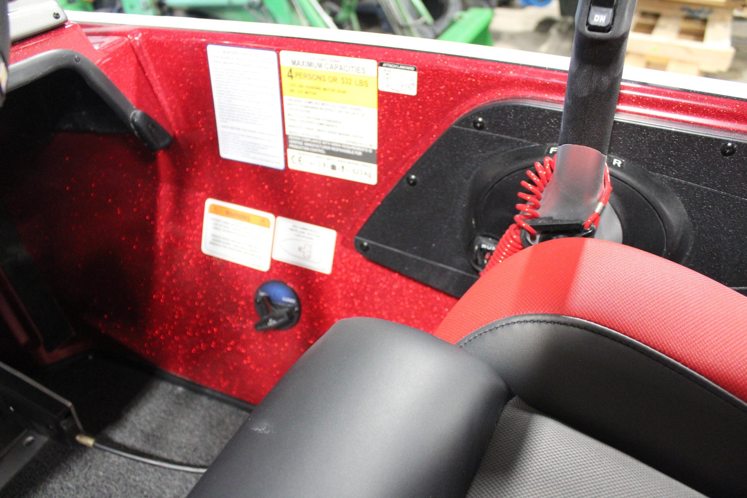 Interior of 2026 Nitro Z19 XL Pro boat with red accents and control panel.