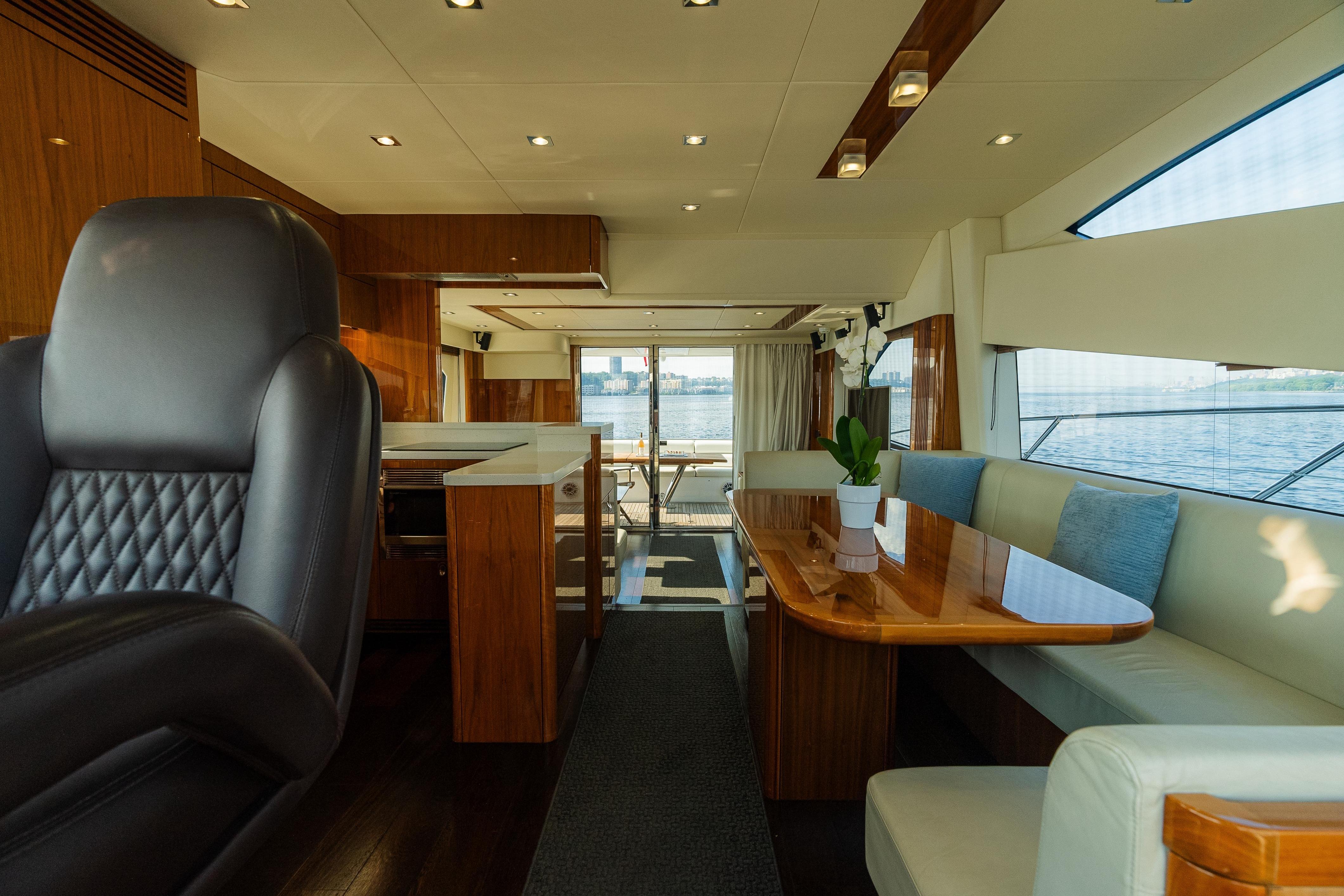 Luxurious interior of 2016 Sunseeker Manhattan 65 yacht with elegant seating and wood finishes.