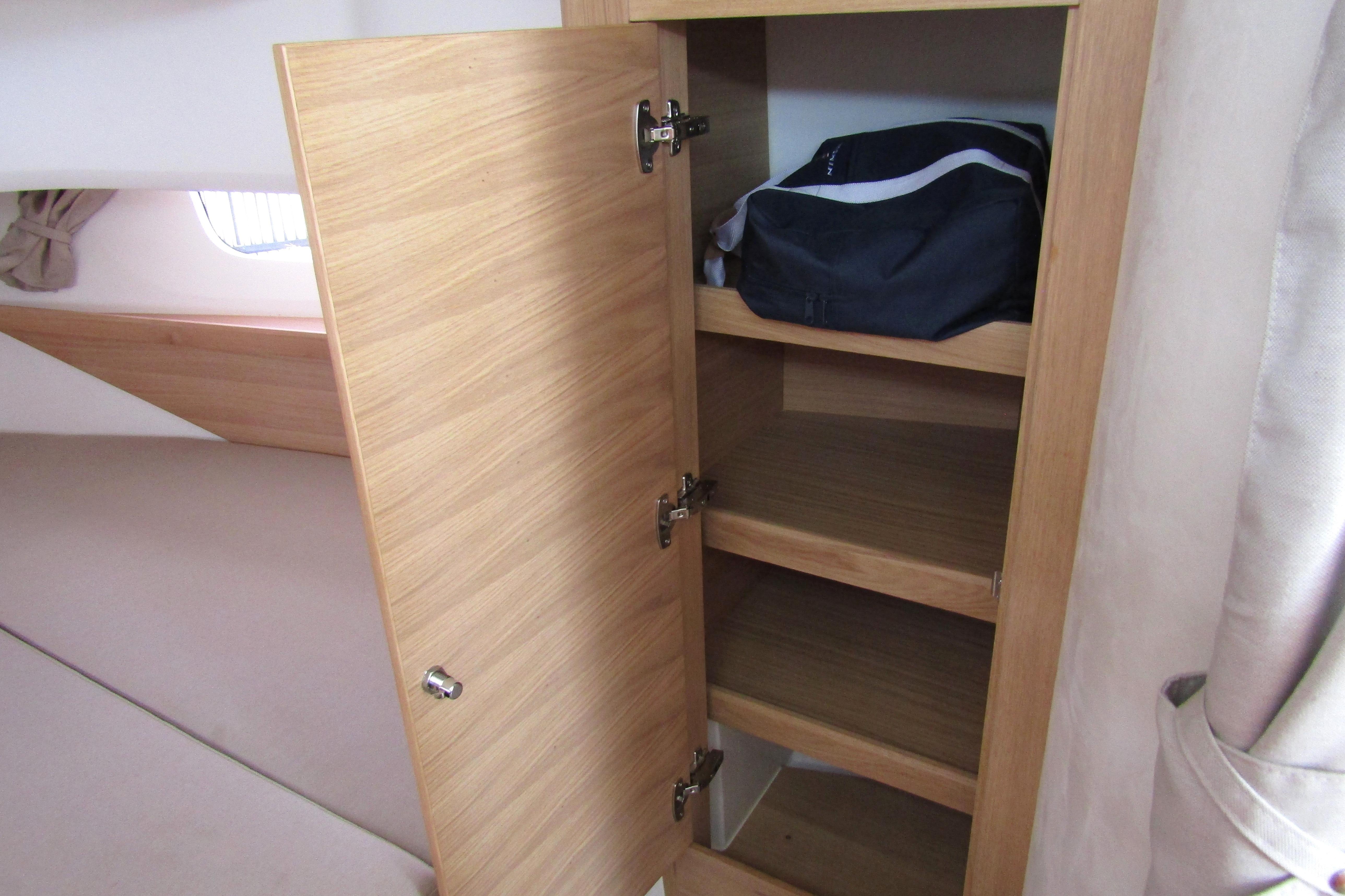 Wooden cabinet with shelves inside Nimbus Tender 11, 2025 model, featuring a bag.