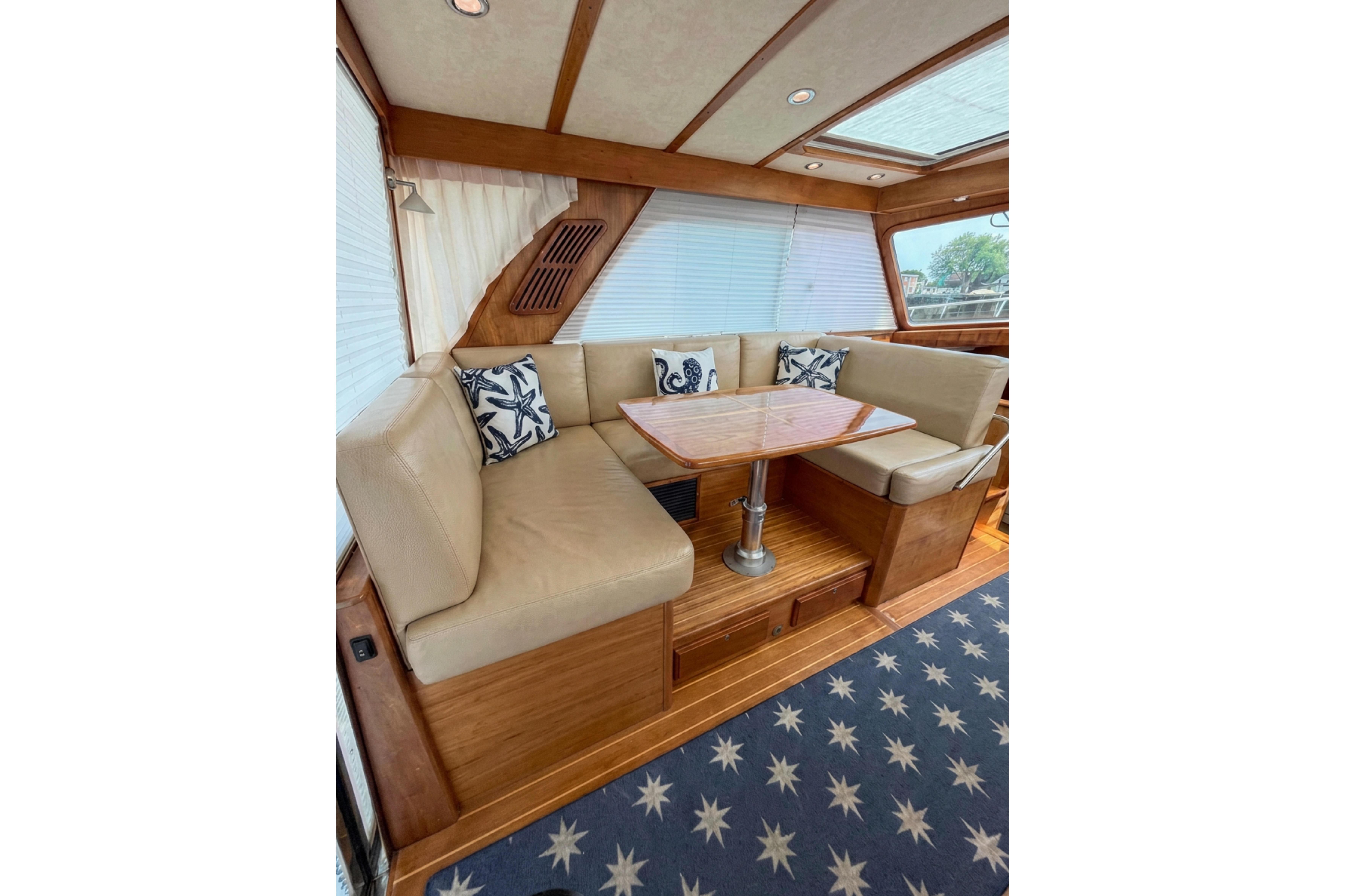 Interior of 2013 Sabre 38 Salon Express with cozy seating and nautical decor.