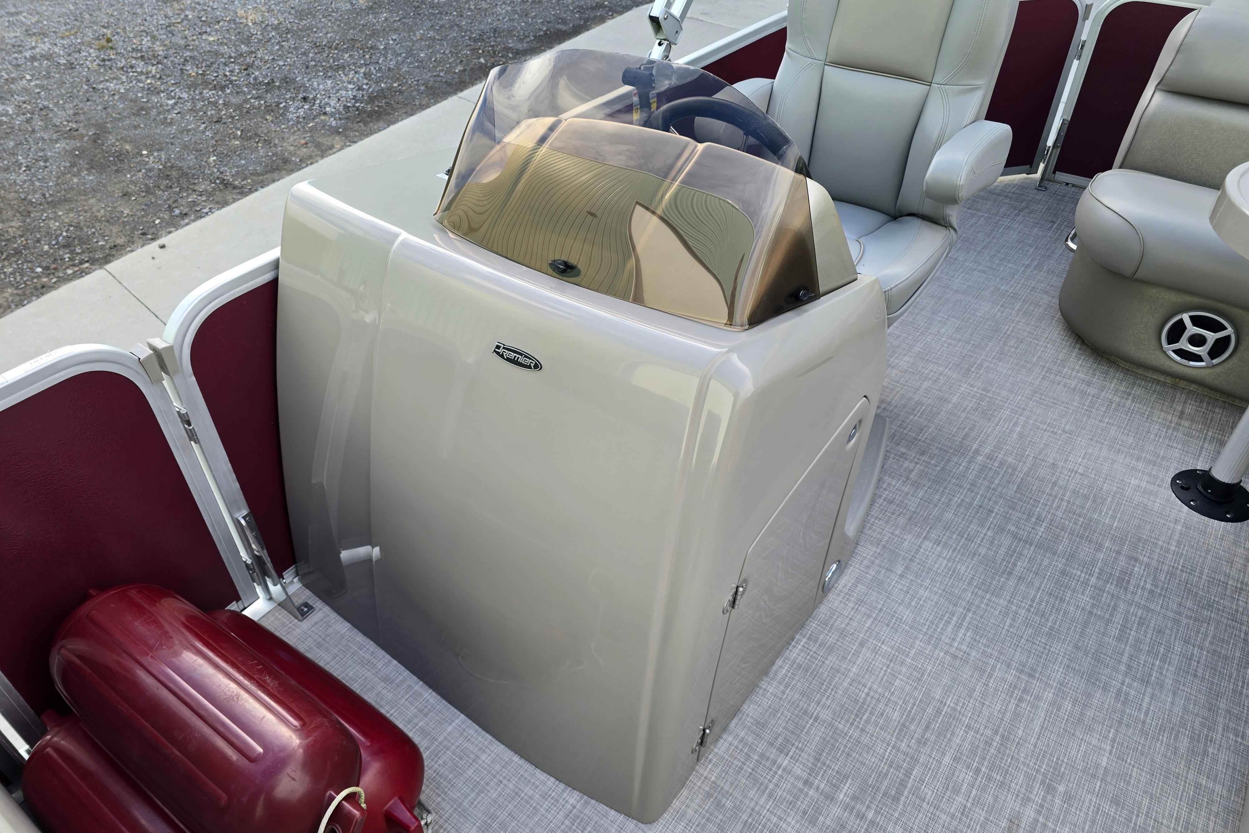 2017 Premier 220 SunSation boat interior with steering console and seating.