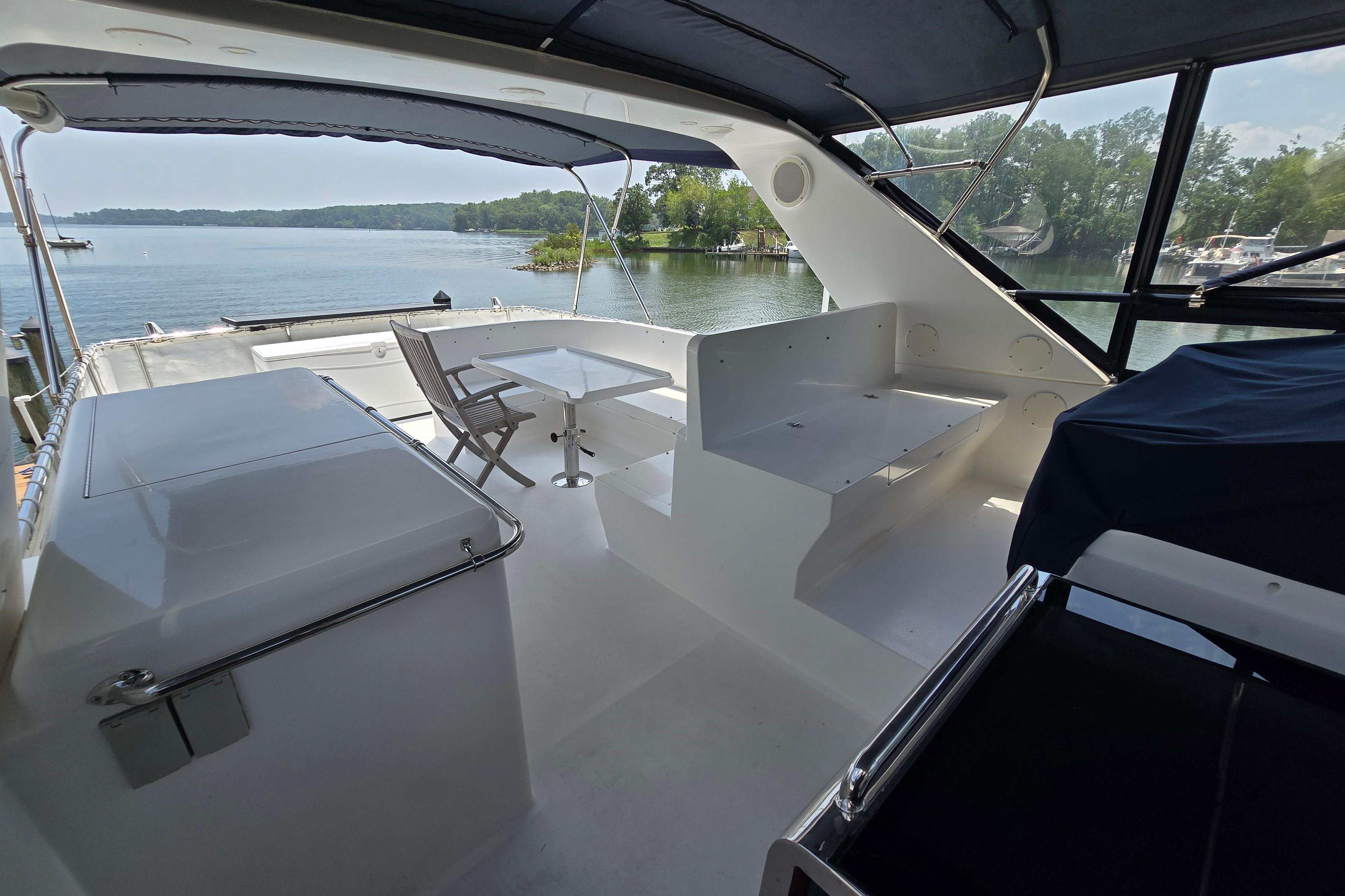 Luxurious 2004 Grand Harbour 58 yacht interior with seating and scenic waterfront view.