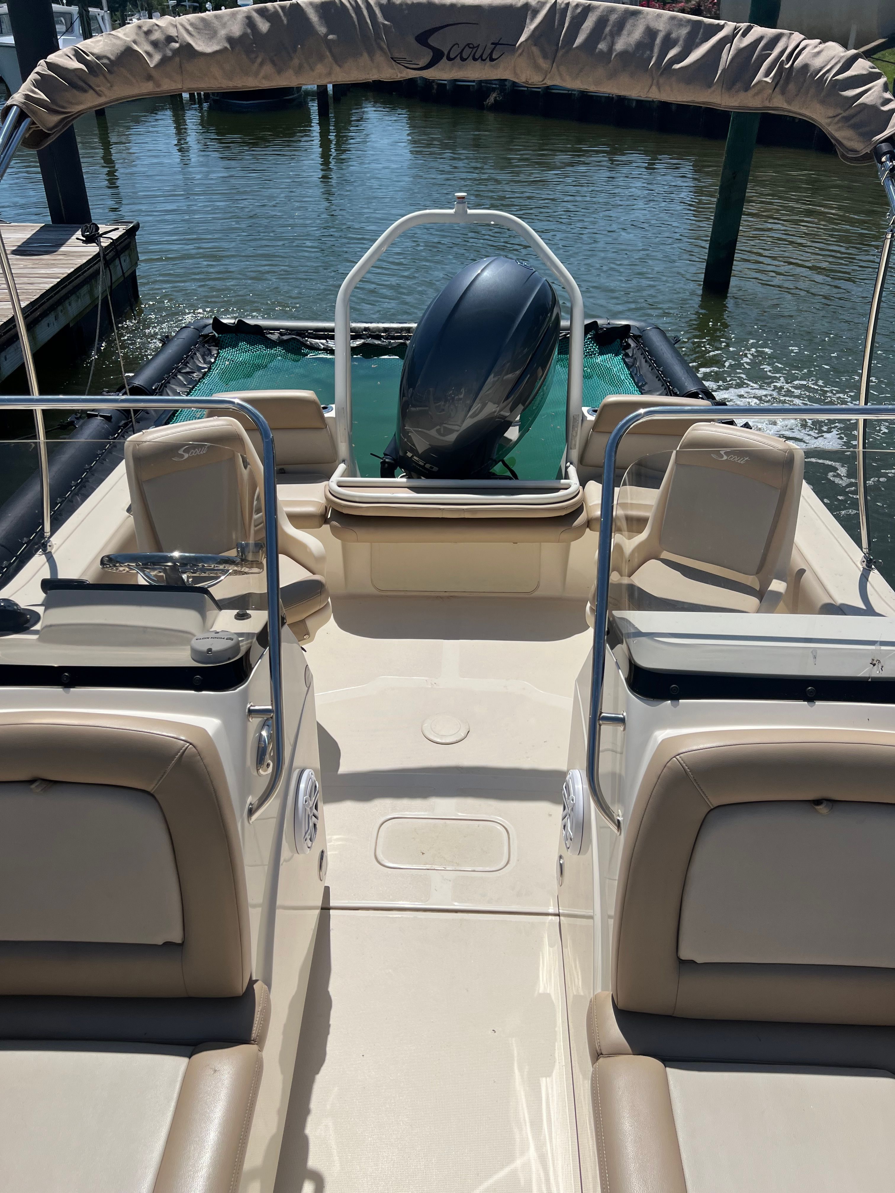 The image shows the cockpit of a 2021 Scout 195 Sport Dorado boat docked.
