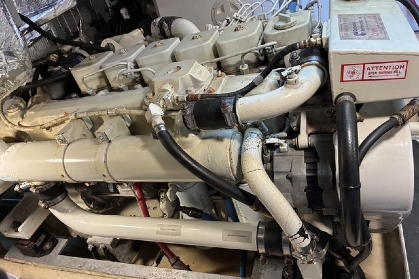 Engine of a 2000 Nordic Tug 37 boat, showcasing intricate mechanical components.