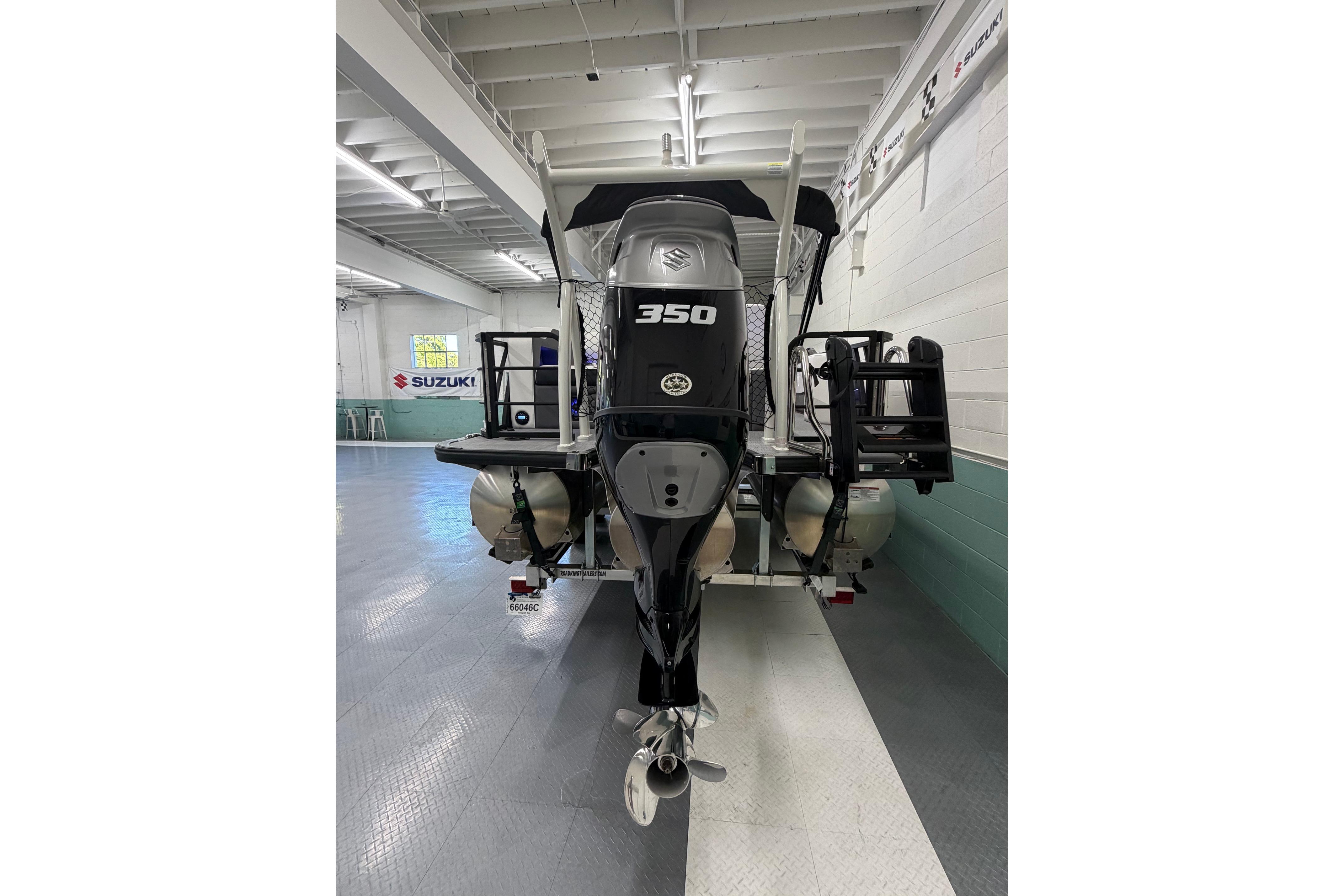 2026 South Bay 525SB2 boat with Suzuki 350 engine in showroom.