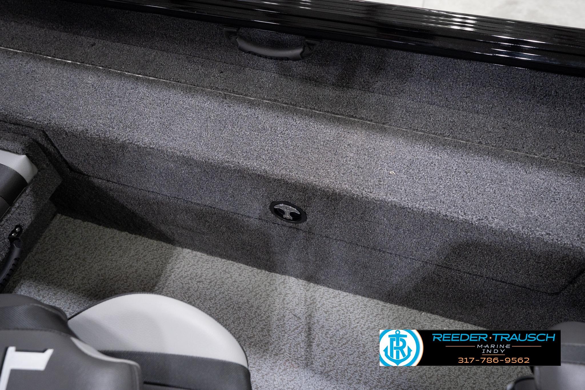 Interior view of 2026 Lund 1775 Impact XS SS boat, featuring carpeted flooring and seating.